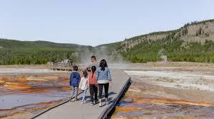 292 A Group Of People Standing On A Bridge Over A River
