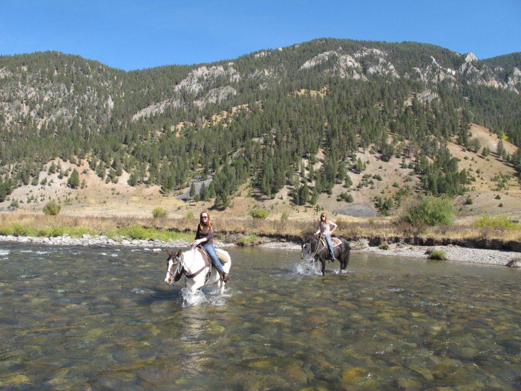 38 People Riding Horses In A River