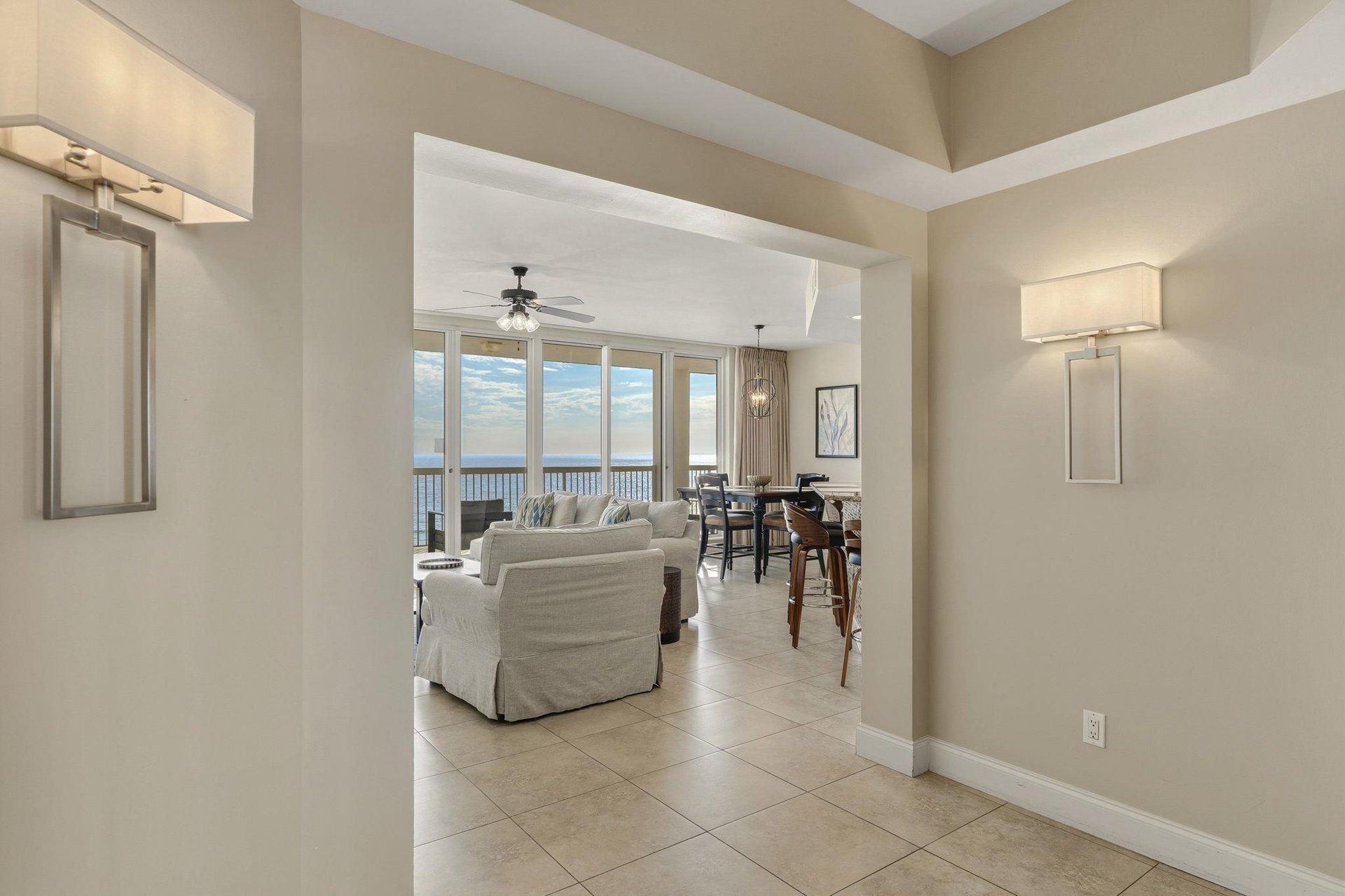 Step into your elegant coastal retreat where ocean views frame the open living space, perfect for relaxing after beach days.