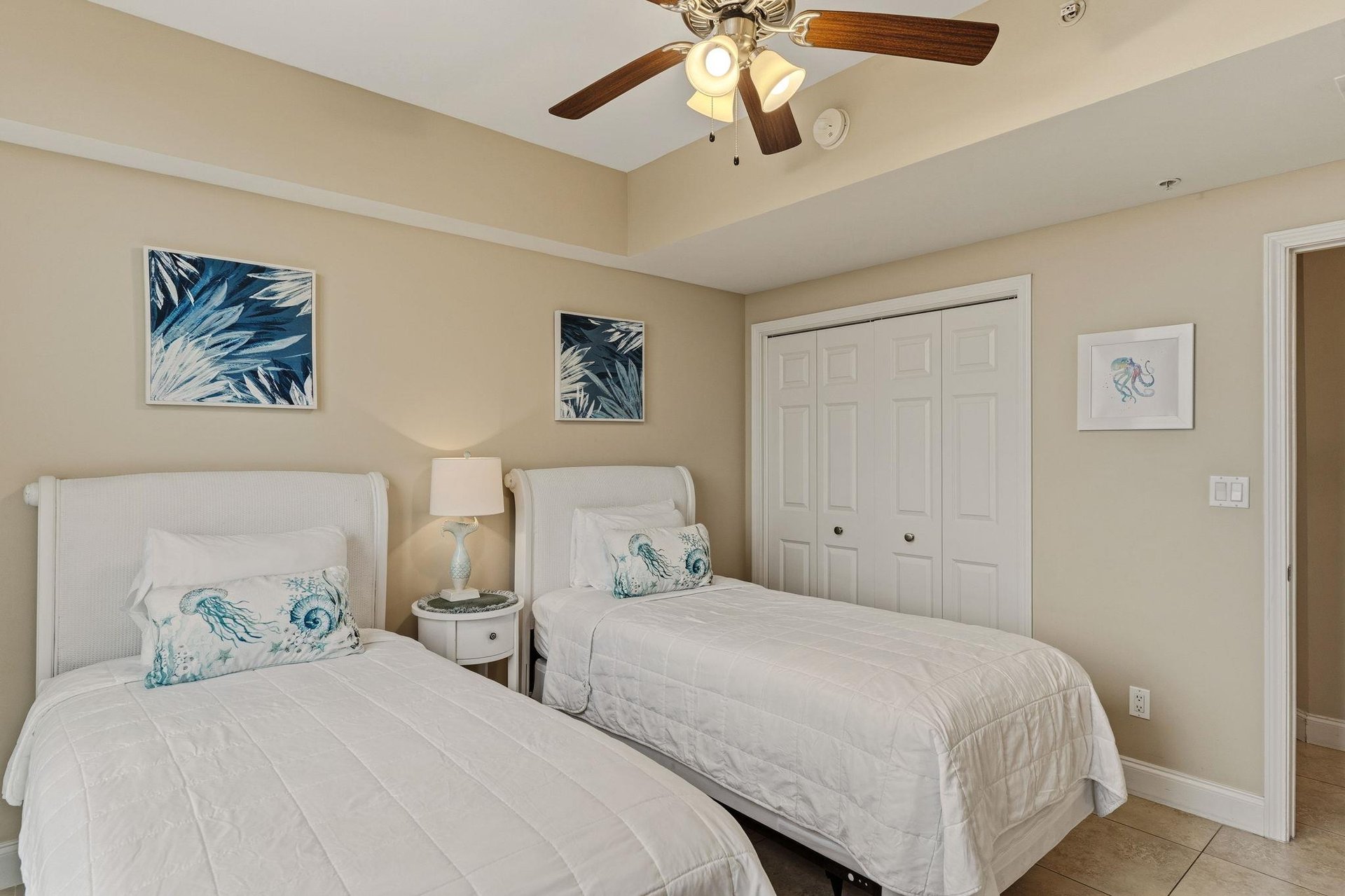 Bedroom 3 Drift off in this coastalthemed bedroom where two comfortable beds await, complete with soothing seainspired artwork and gentle ceiling fan breezes.