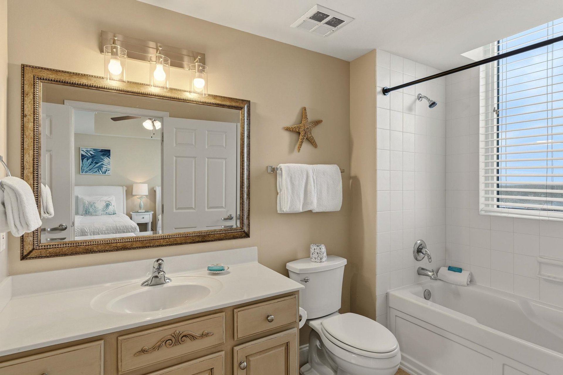 Bathroom 3 Refresh in your coastalthemed bathroom with elegant lighting, warm vanity, and relaxing tubshower combo.