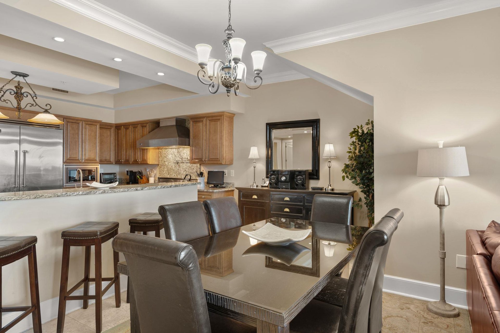 Gather around your elegant dining table or relax at the kitchen bar in this openconcept space with rich granite counters.