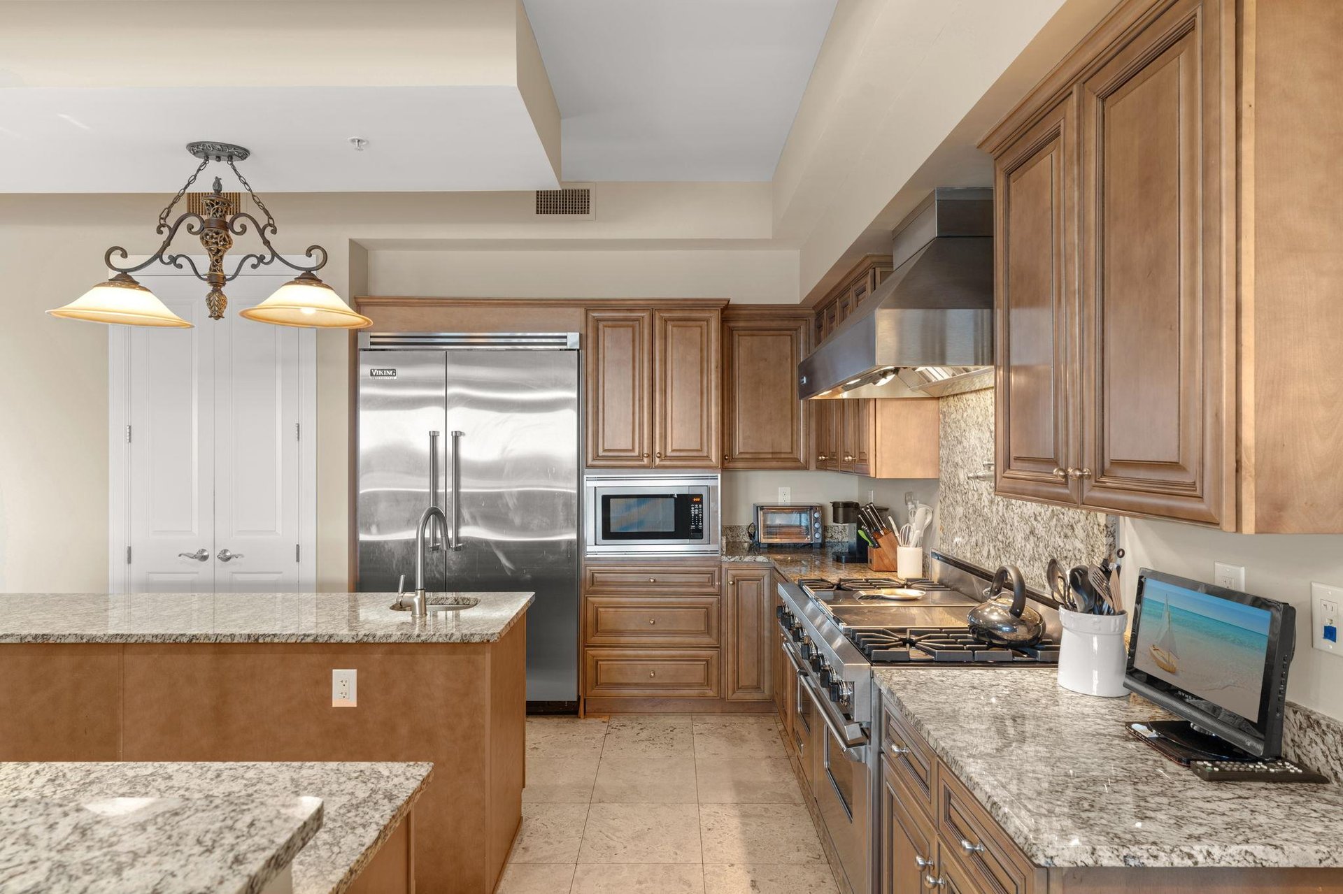 Your gourmet kitchen features granite countertops, stainless steel appliances, and warm wood cabinetry for memorable meal preparation.