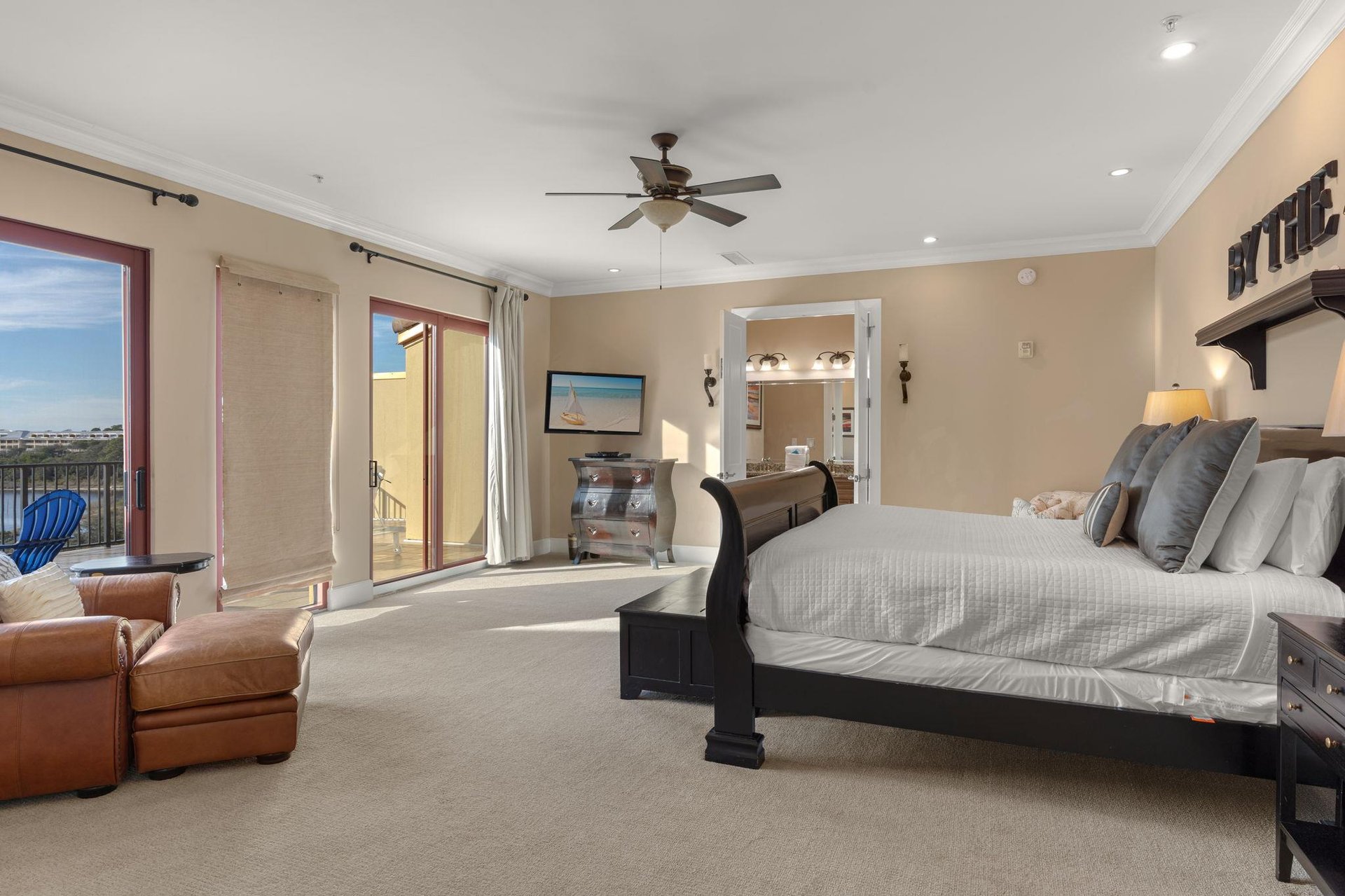 Your spacious master suite features elegant furnishings, balcony access, and serene views for the perfect retreat.