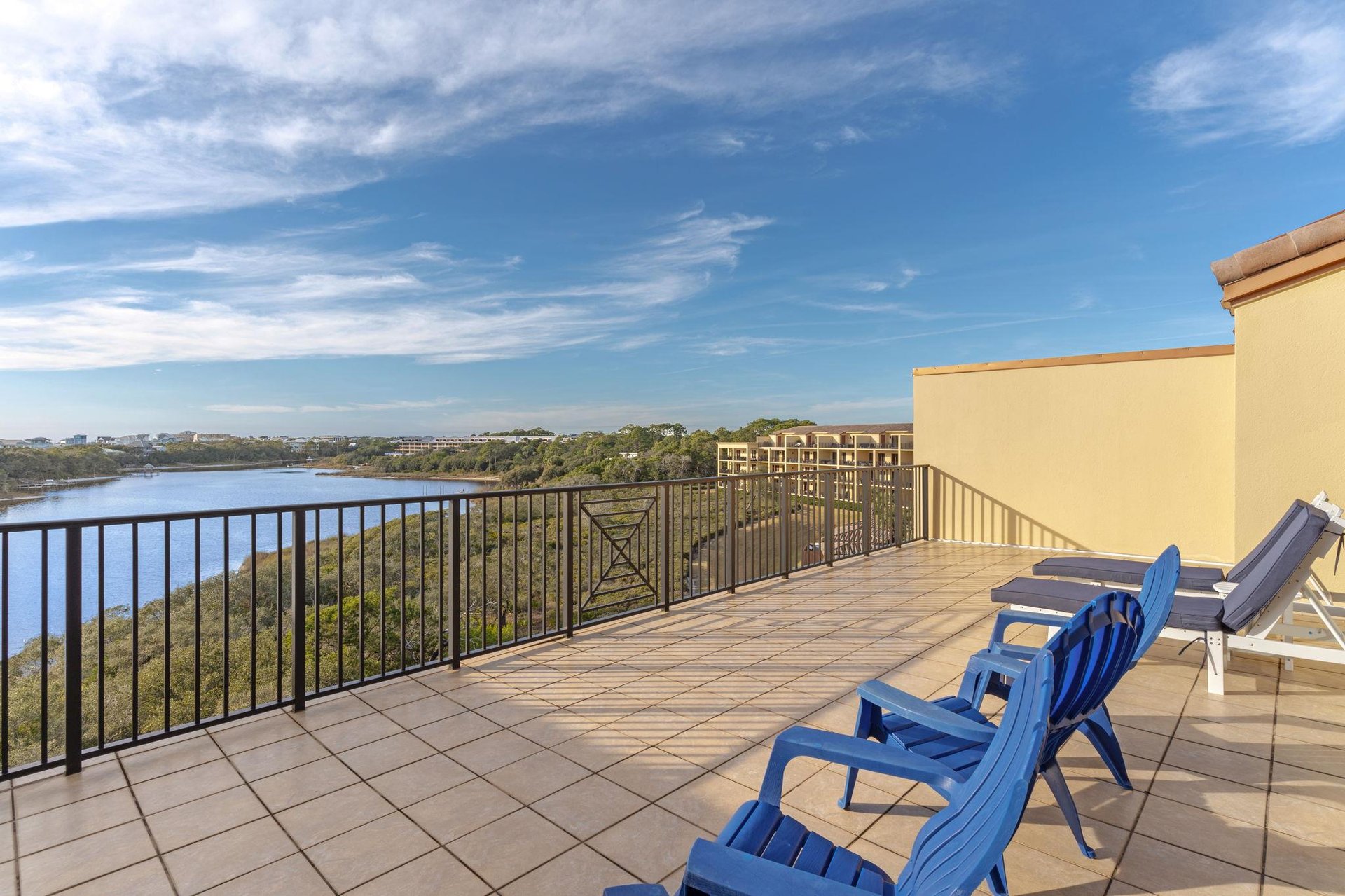 Spacious lakefront terrace with comfortable seating where you can unwind while taking in stunning water views and peaceful surroundings.