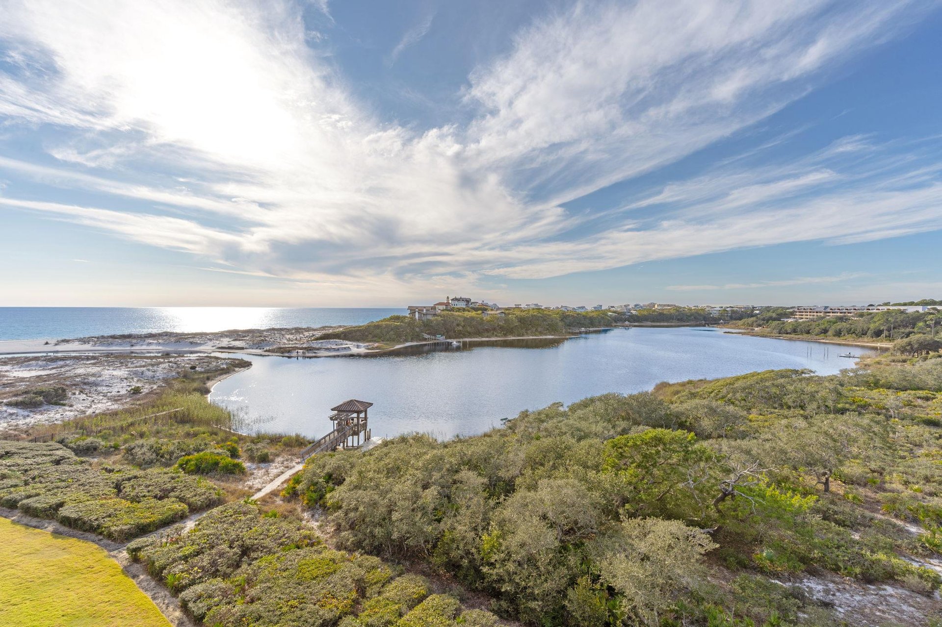Stunning coastal lagoon with pristine waters, lush vegetation, and charming observation tower creating a peaceful natural sanctuary.