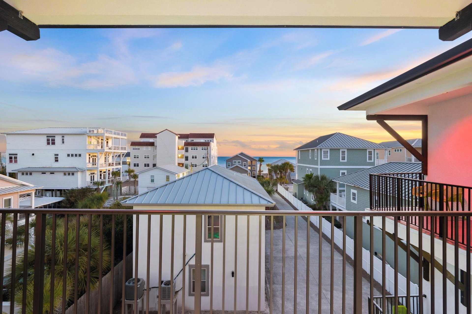 Stunning sunset views of beach houses and coastal architecture from this covered balcony.