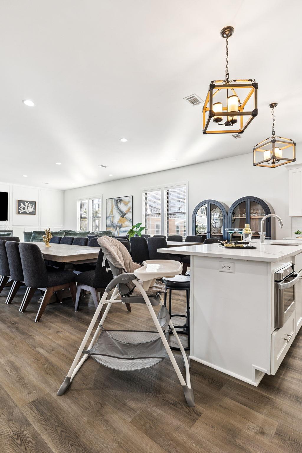 Cook meals in the spacious kitchen while little ones sit safely nearby, then gather at the dining table for memorable family moments together.