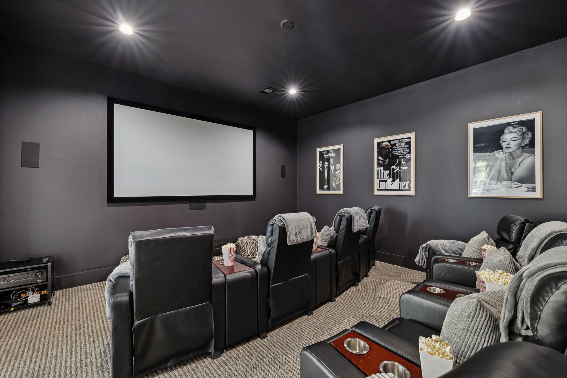 Step into the private cinema with plush reclining seats, cozy blankets, and classic movie posters—perfect for memorable movie nights together.