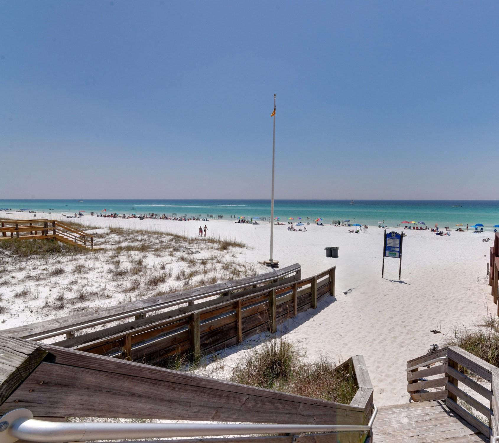 Pristine white sand beach with crystalclear turquoise waters awaits just steps from the property via convenient boardwalk access.