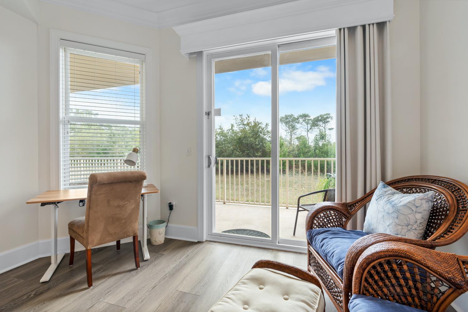 Spacious Primary King Suite featuring a comfortable desk area for work or planning your day.