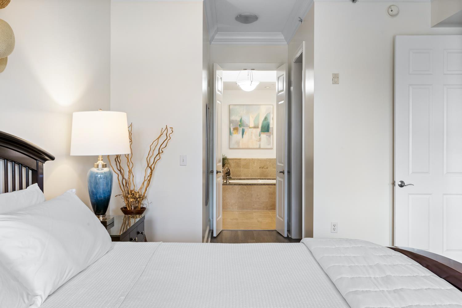 Primary bedroom with a private ensuite bathroom, offering a relaxing coastal retreat.