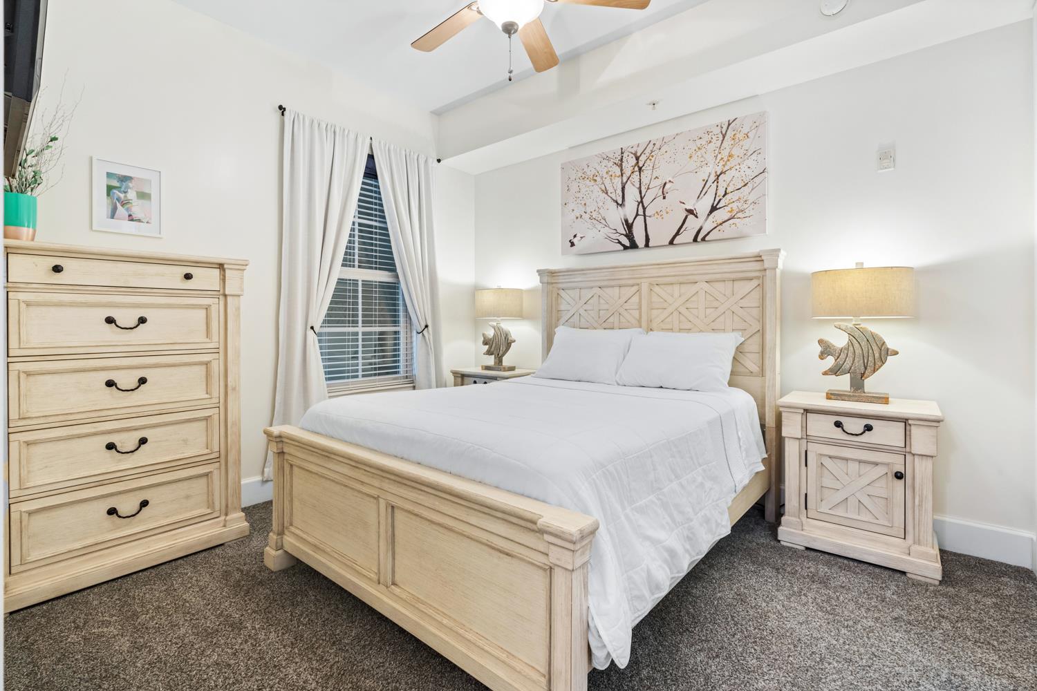 Comfortable guest bedroom featuring a queen bed and ample drawers to unpack and settle in while on vacation.