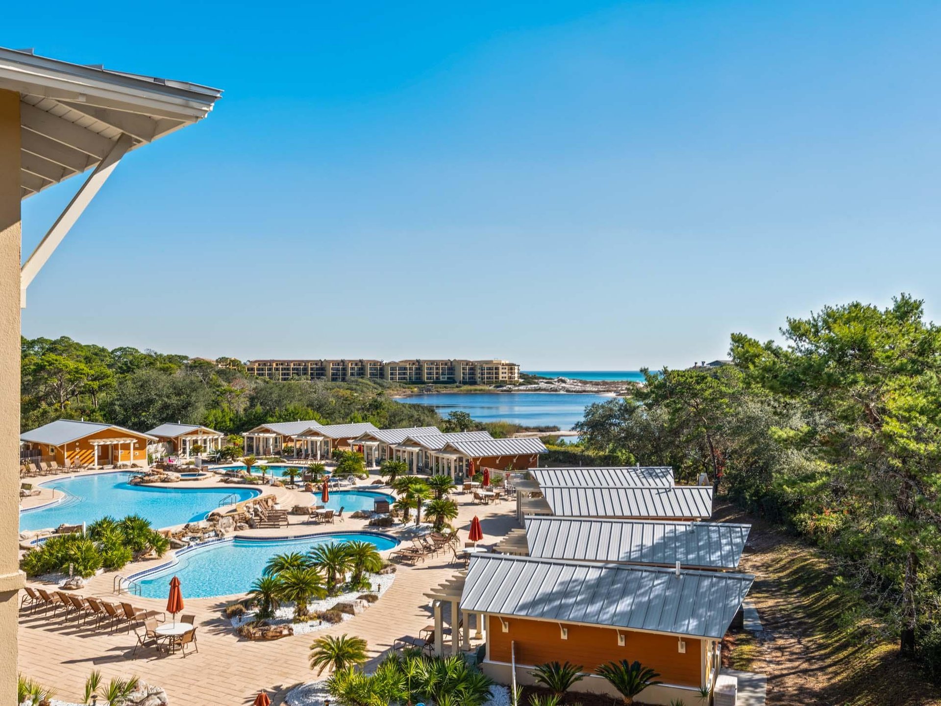 Resortstyle amenities with swimming pools, gulf and lake views surrounded by lush tropical landscaping.