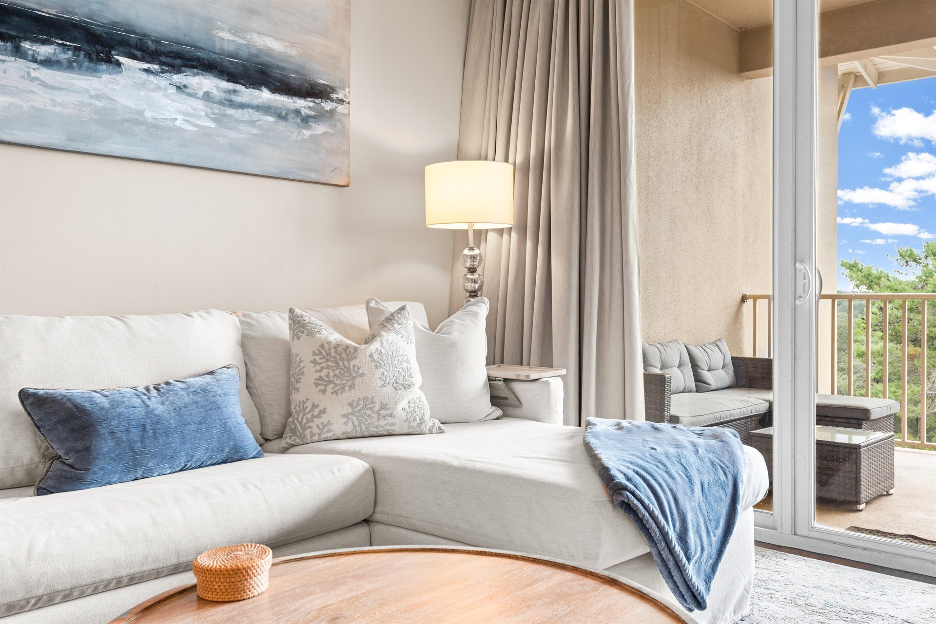 Sink into the plush sofa surrounded by soft coastal accents