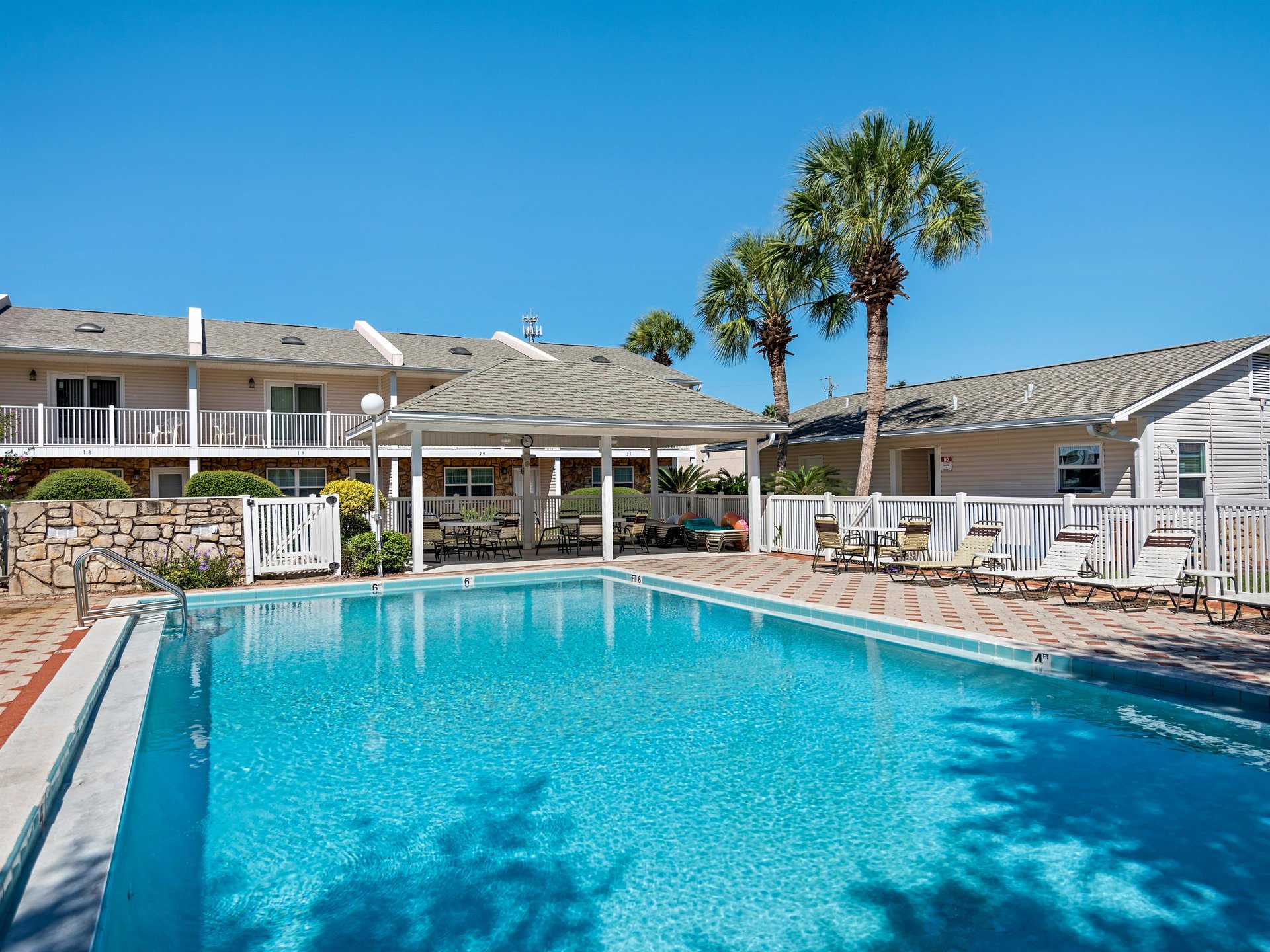 The perfect poolside retreat awaits under endless blue skies.