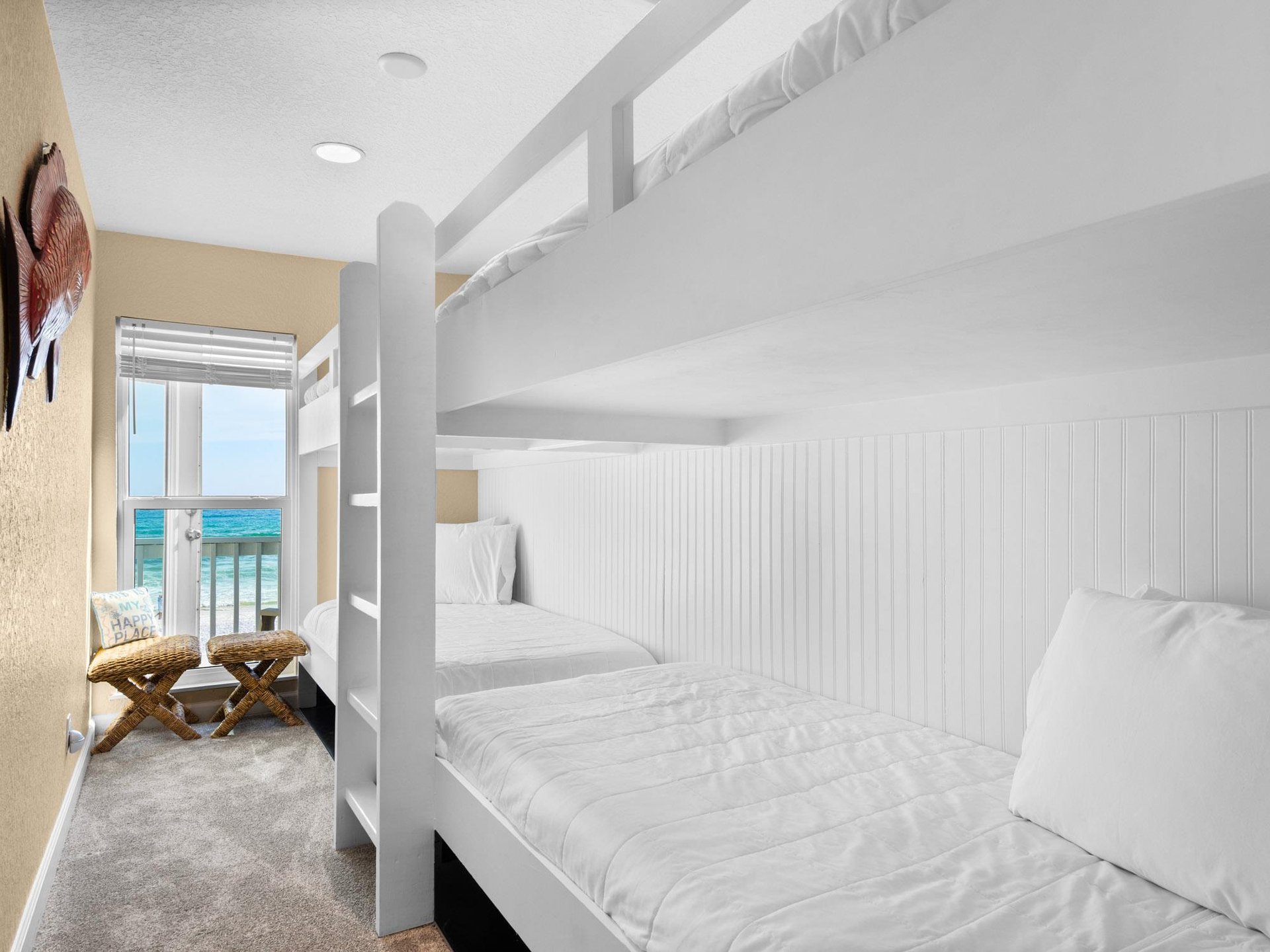 Your bunk beds offer cozy comfort with ocean views through the window, perfect for families seeking beachside relaxation.