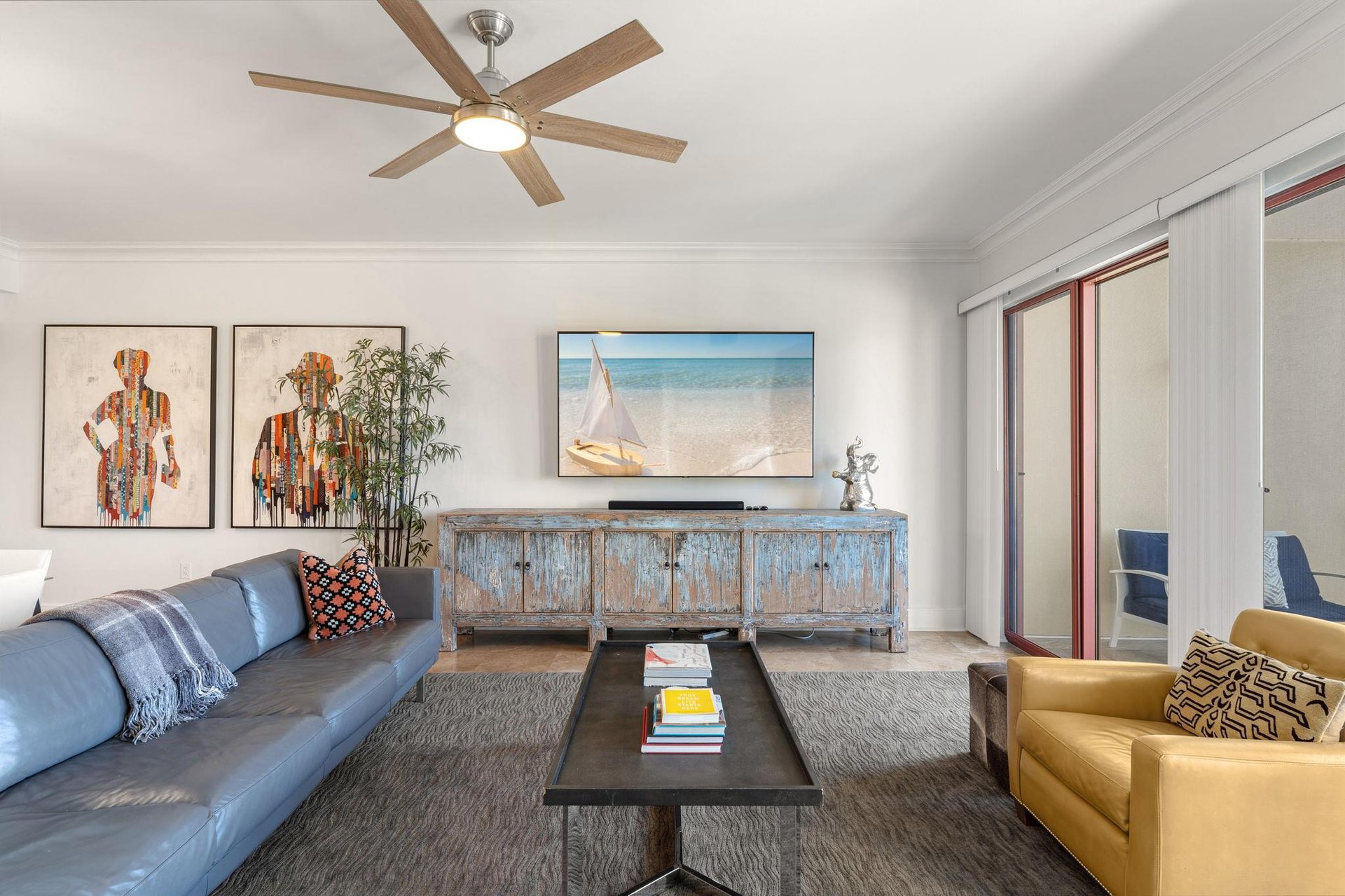 Relax in this sophisticated living space with coastal charm, and vibrant artwork.