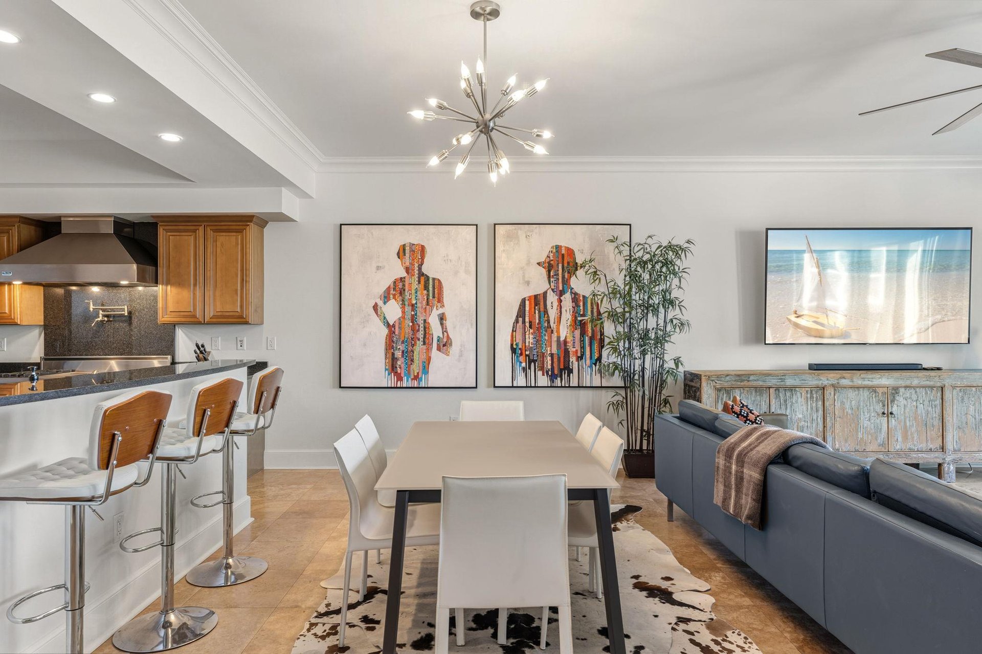 Dine in a modern, open space with a table for 6 and kitchen bar seating for 3.