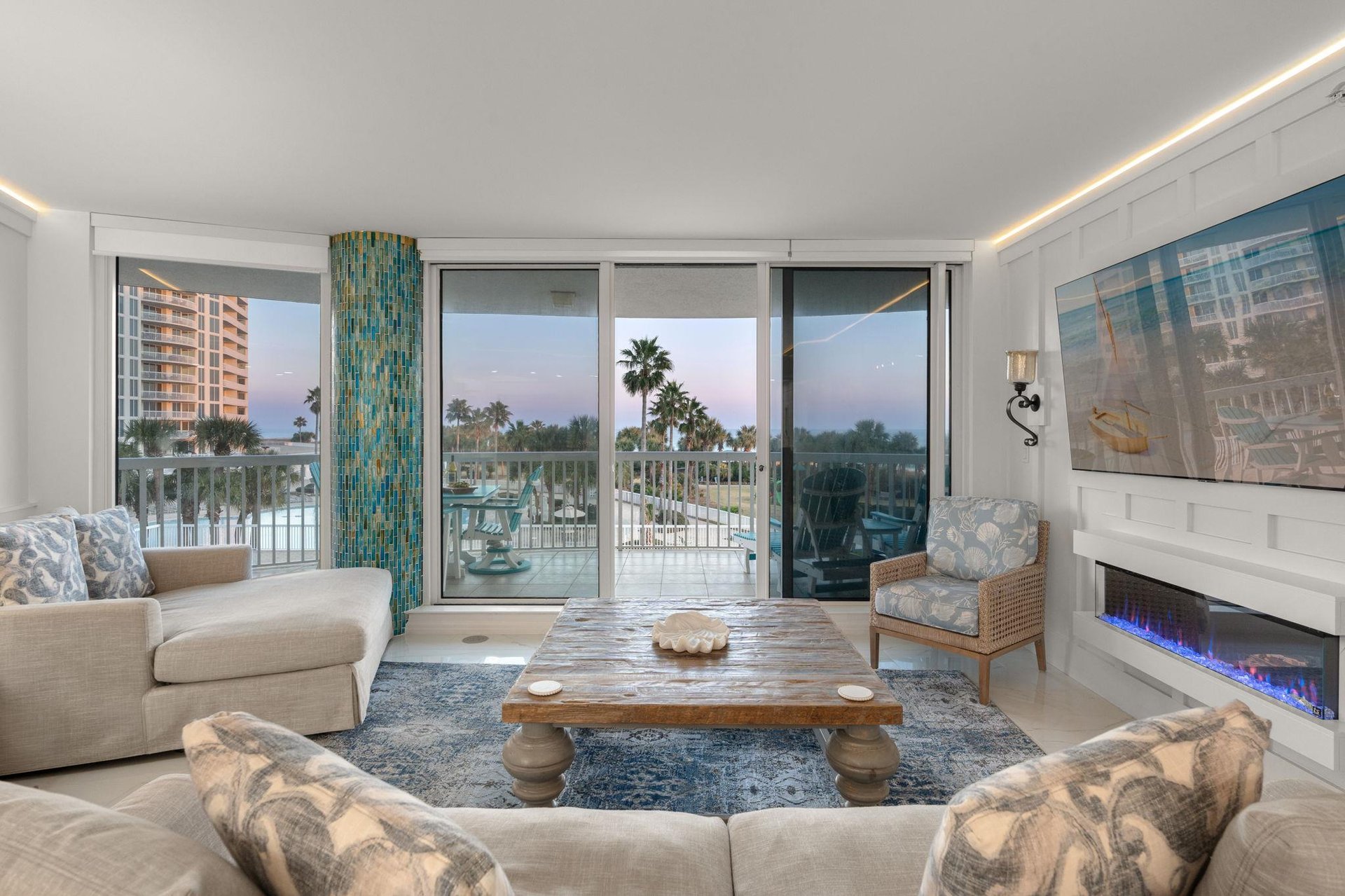 Relax with stunning water views, cozy fireplace, and direct balcony access to tropical scenery.