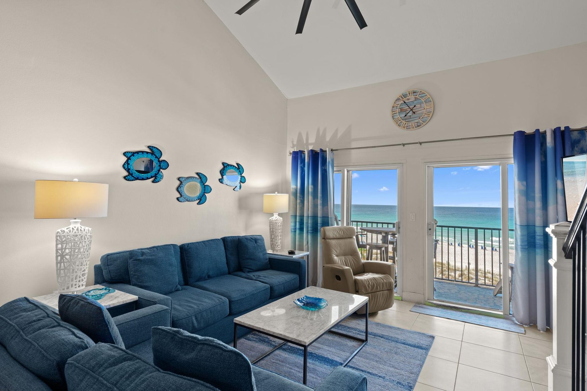 Relax in your coastal living room, where oceanthemed décor and plush seating welcome you. Step through the balcony doors to feel the sea breeze and hear the waves—your beachfront escape awaits.