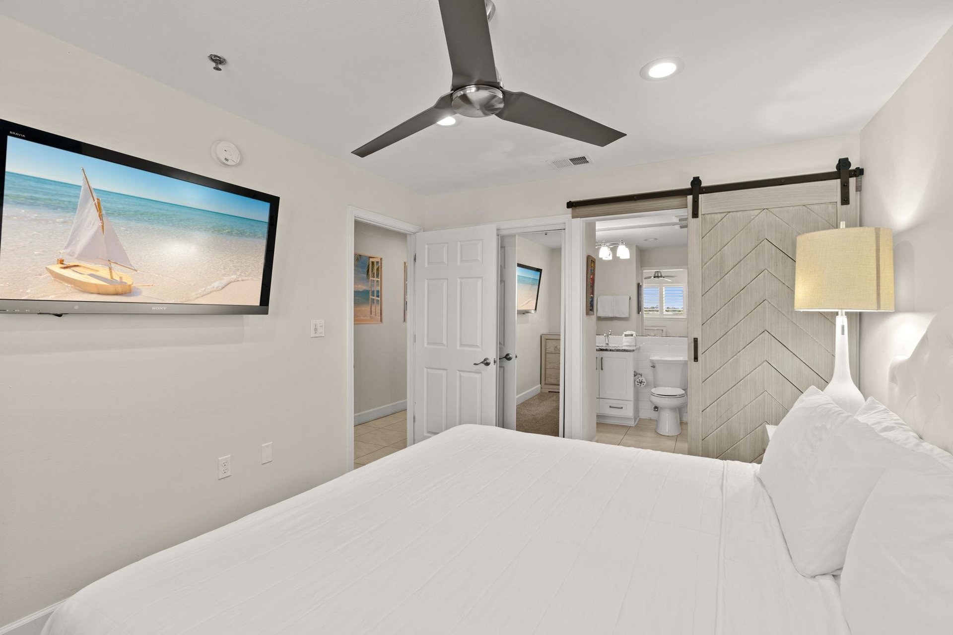 Sink into crisp white linens and let coastal breezes from the ceiling fan lull you to sleep.
