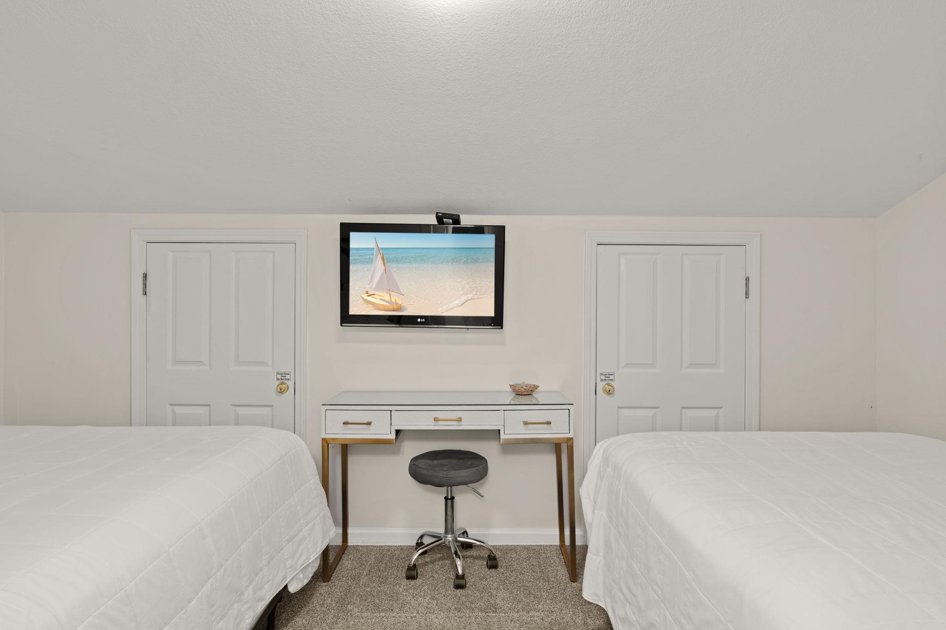 Two plush beds await your arrival, with a workspace in between for any essentials and a flatscreen TV to unwind with after your adventures.