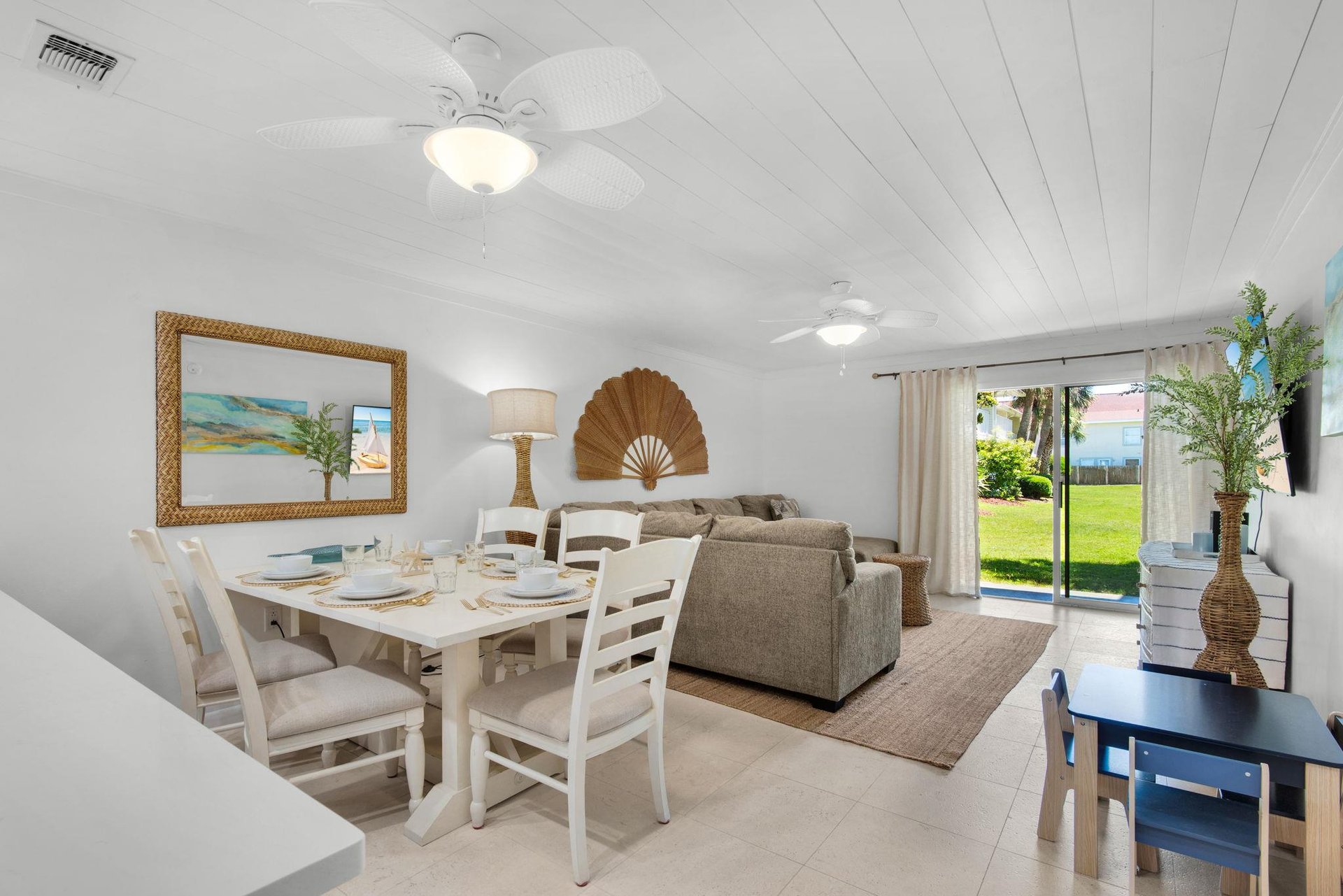 Gather around the welcoming dining table for meals together, then unwind on comfy sofas while enjoying garden views through sliding glass doors.