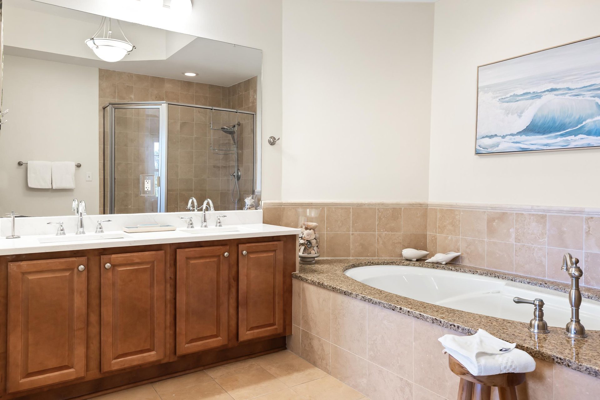Unwind in your spainspired bathroom with dual sinks, a walkin shower, and a soaking tub framed by warm granite—a perfect retreat after exploring the coast.