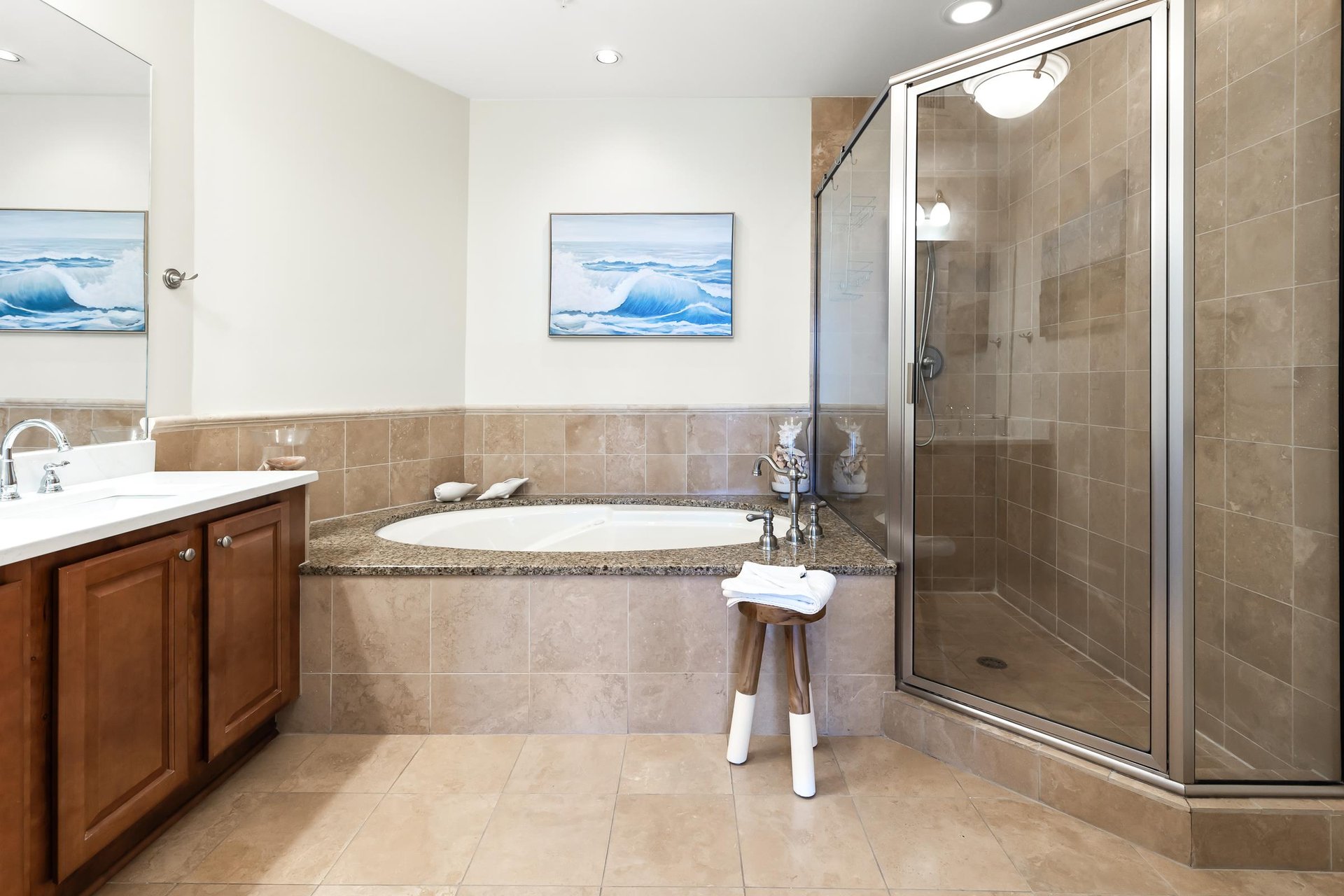 Your spalike bathroom features a soaking tub and walkin shower, perfect for unwinding after exploring. Coastal artwork and warm tones create a soothing retreat.