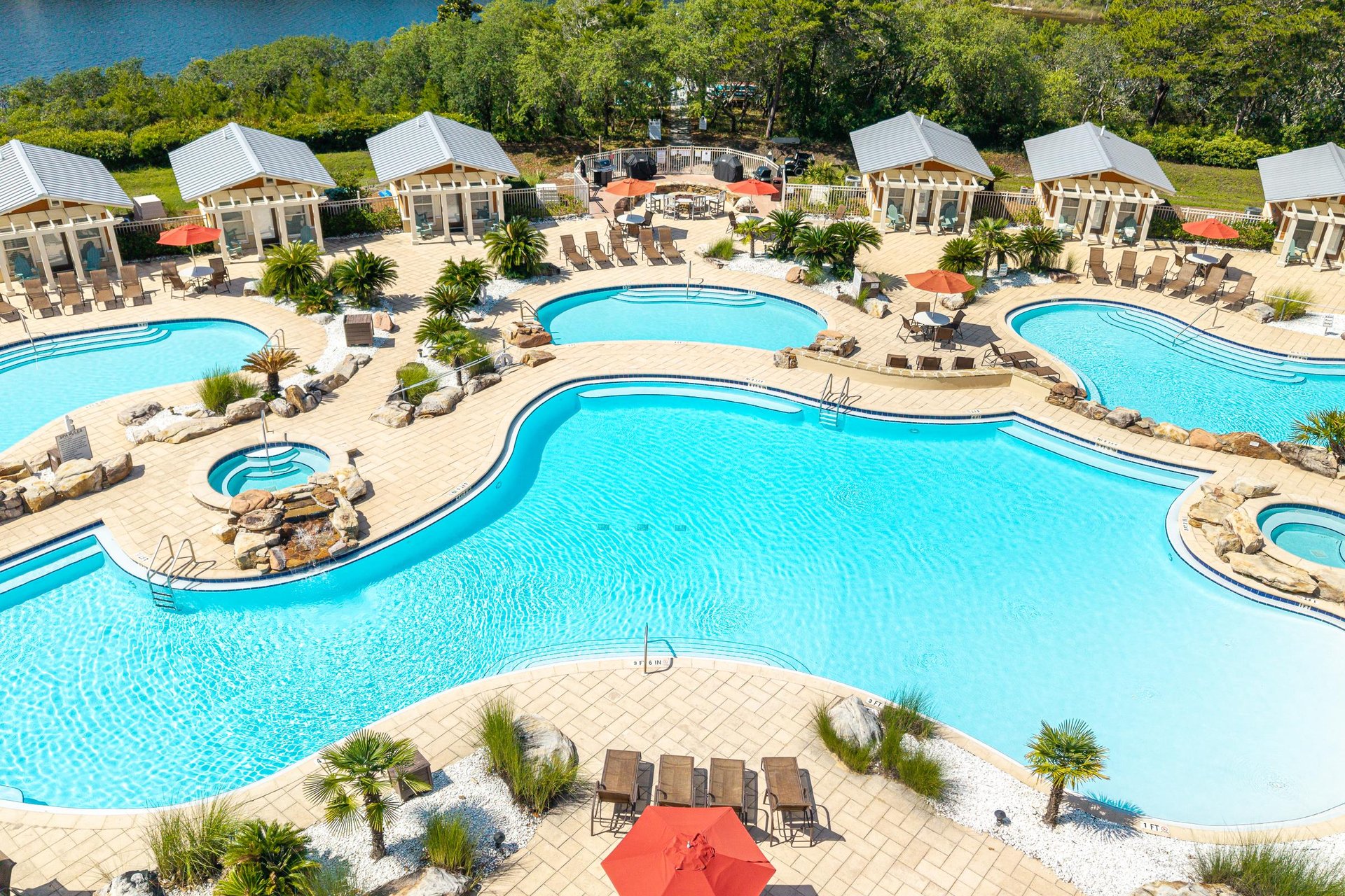 Aerial view of an expansive resortstyle pool complex with Pool Cabanas