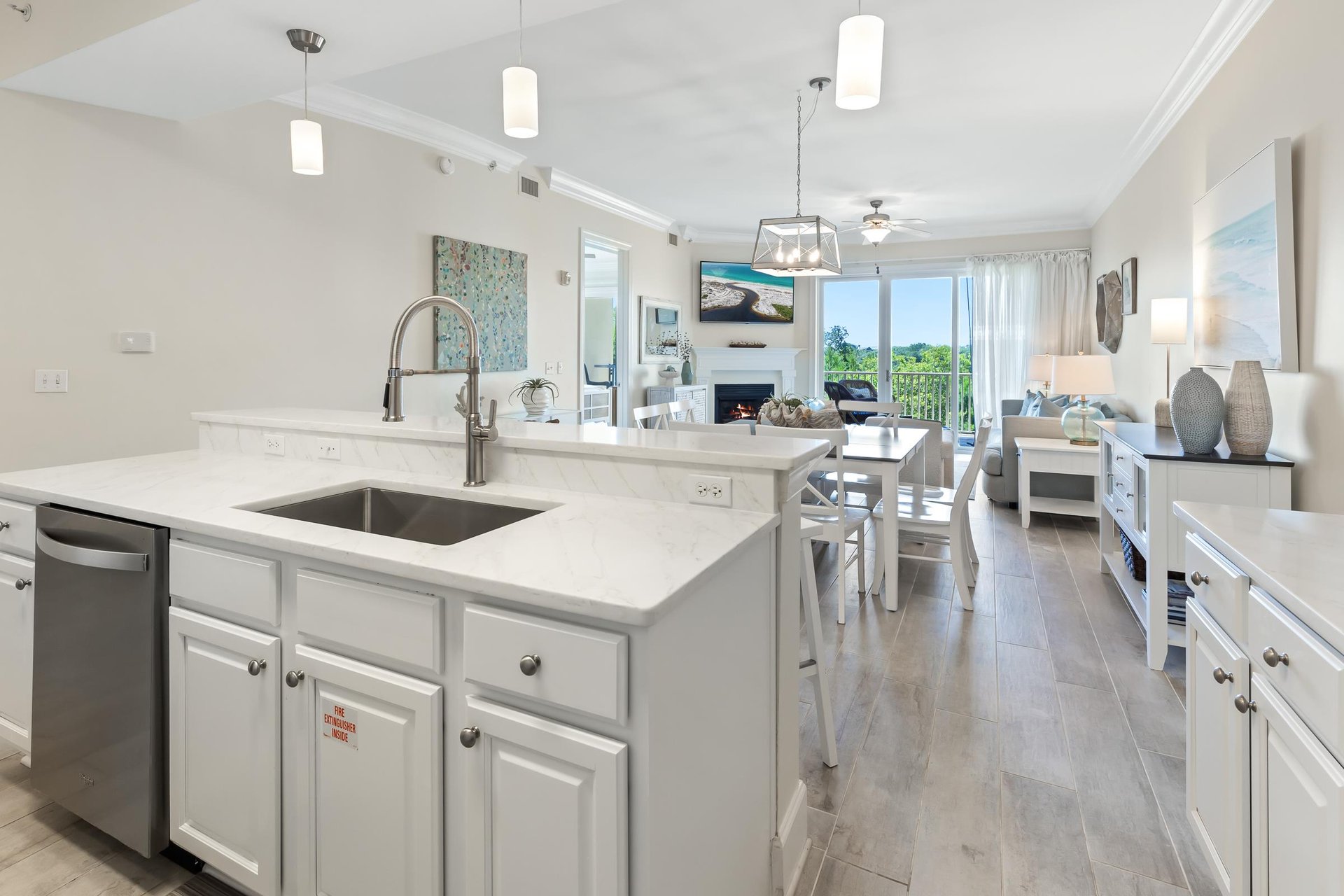 Your bright, open kitchen flows seamlessly into the living and dining areas, perfect for gathering and creating memories together. Soft pendant lighting, modern appliances, and calming coastal décor i