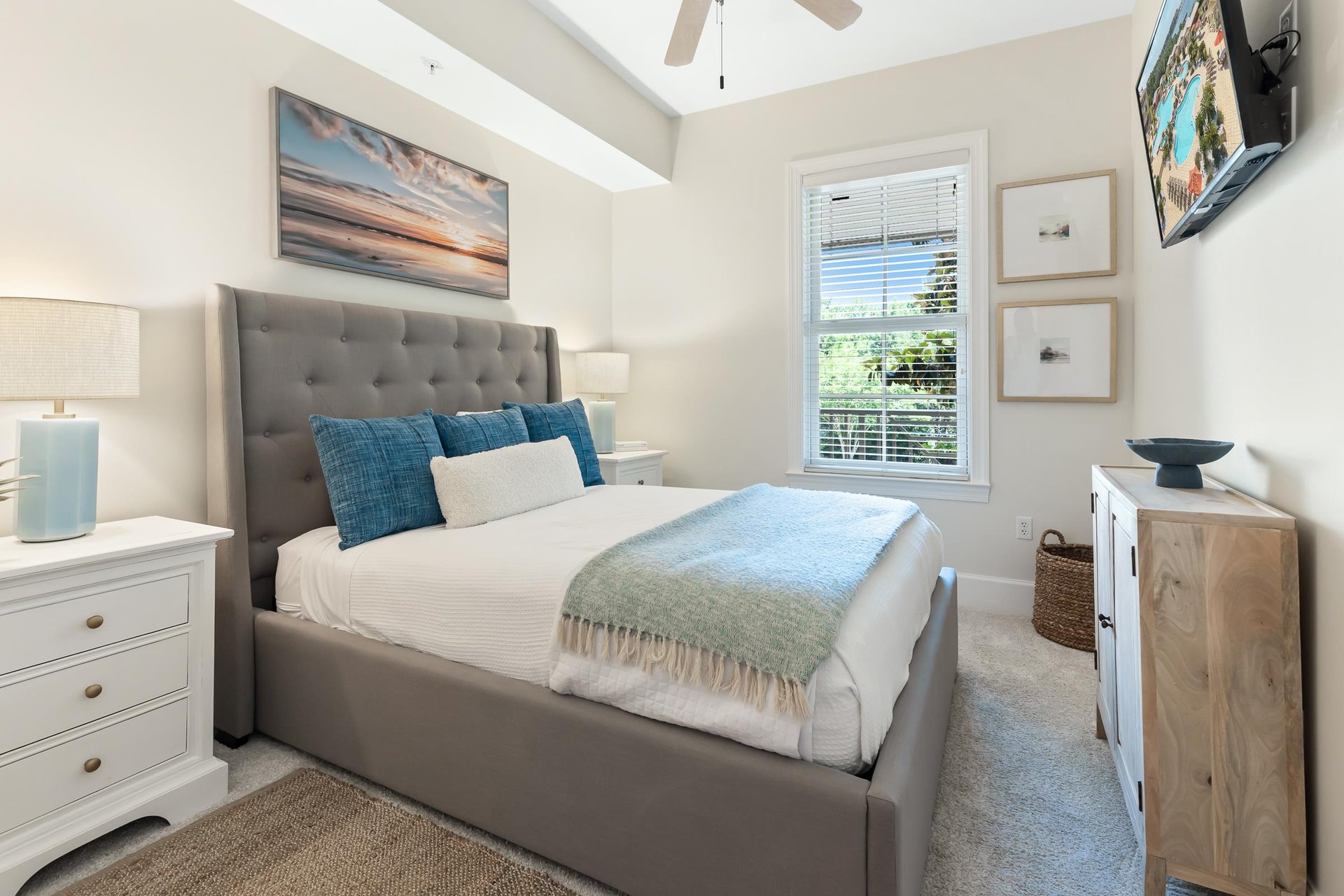 Sink into the plush upholstered bed and let the coastal artwork transport you to peaceful shores. The soft bedding and bright, airy space create your perfect retreat.