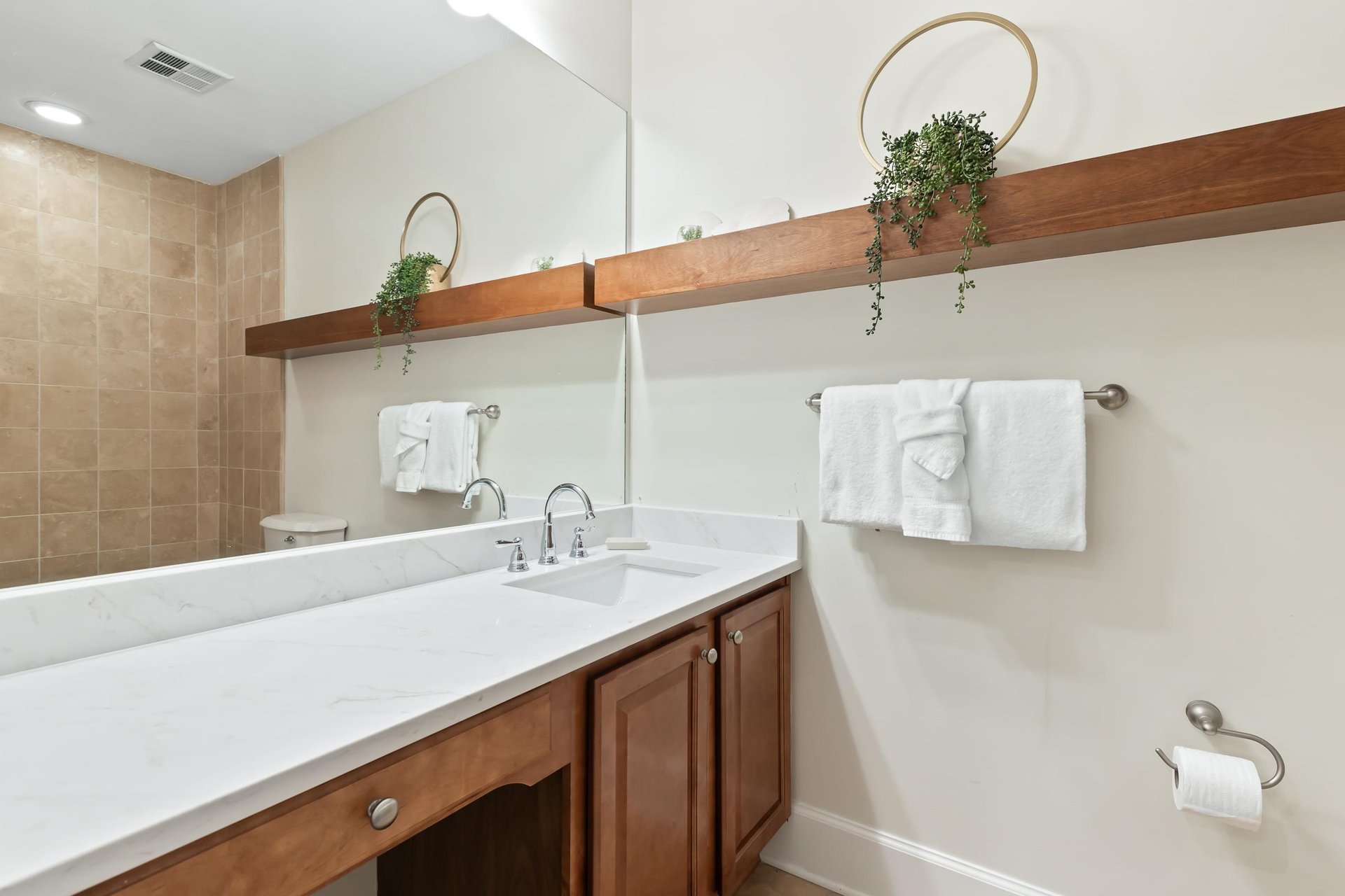 Refresh in your modern bathroom with dual sinks, fresh towels, and natural touches that make your stay feel like home.