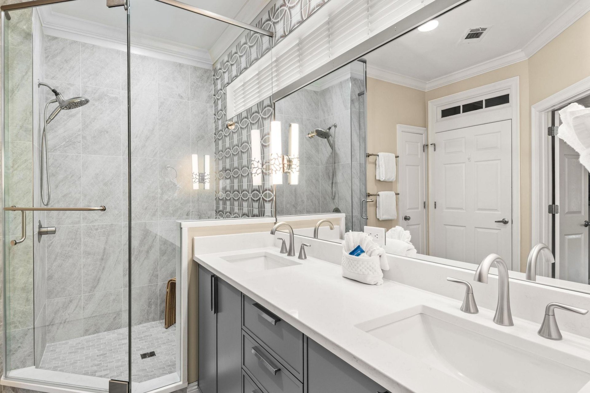 Step into the bright, elegant ensuite bathroom where marble accents and dual sinks give you ample space to refresh.