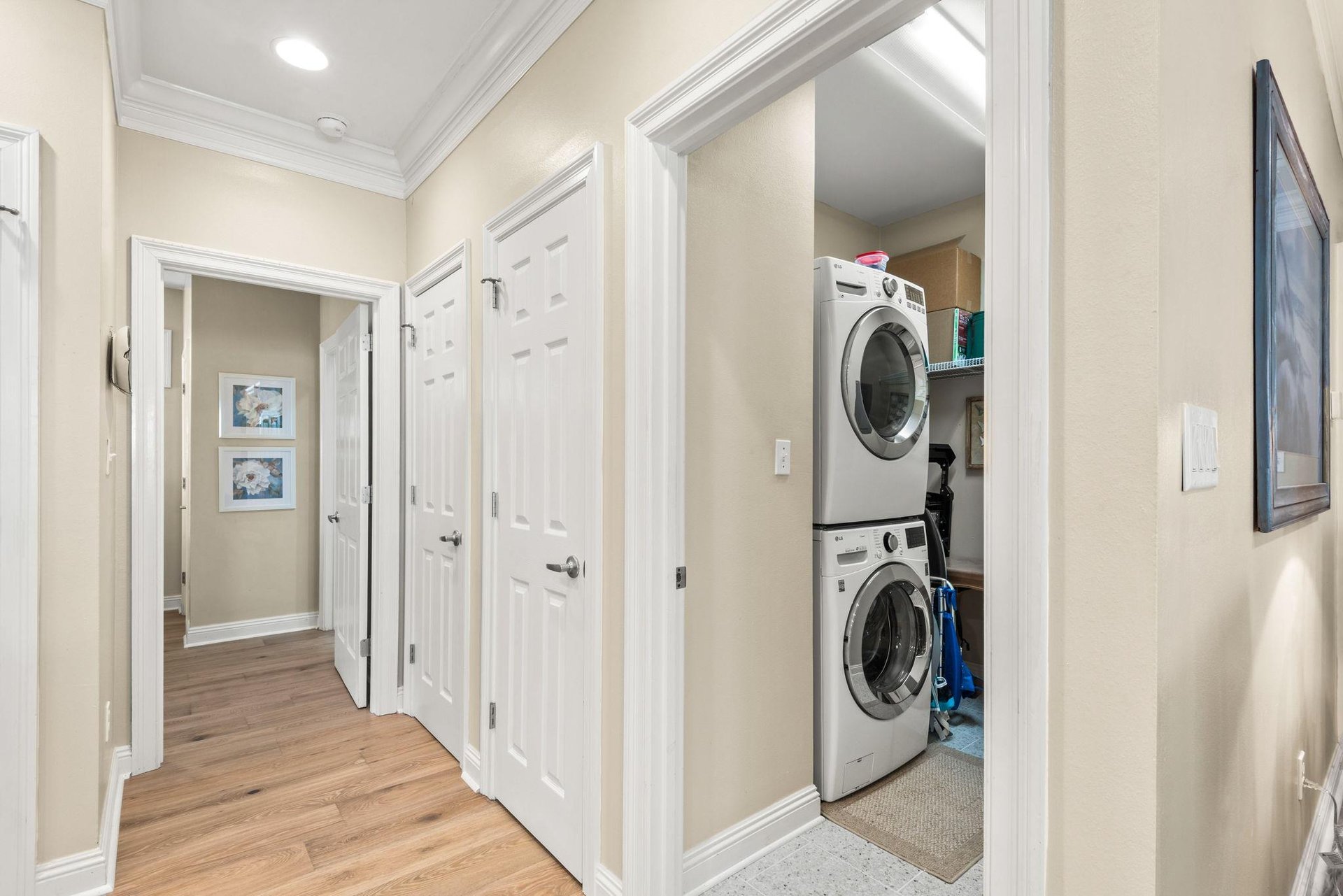 The laundry room features fullsize stacked washer and dryer neatly tucked into a convenient area, keeping your essentials close without compromising style.