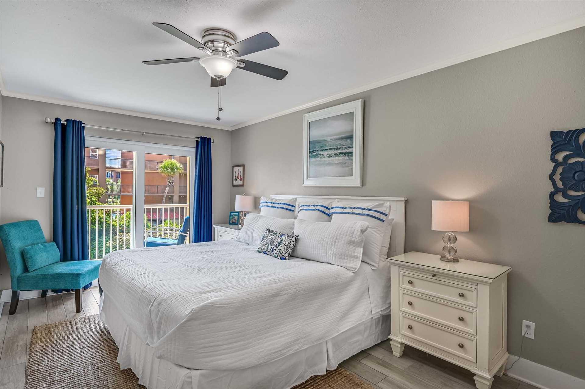 Drift off in the Primary bedroom with coastalinspired tones creating a serene retreat after your beach adventures.
