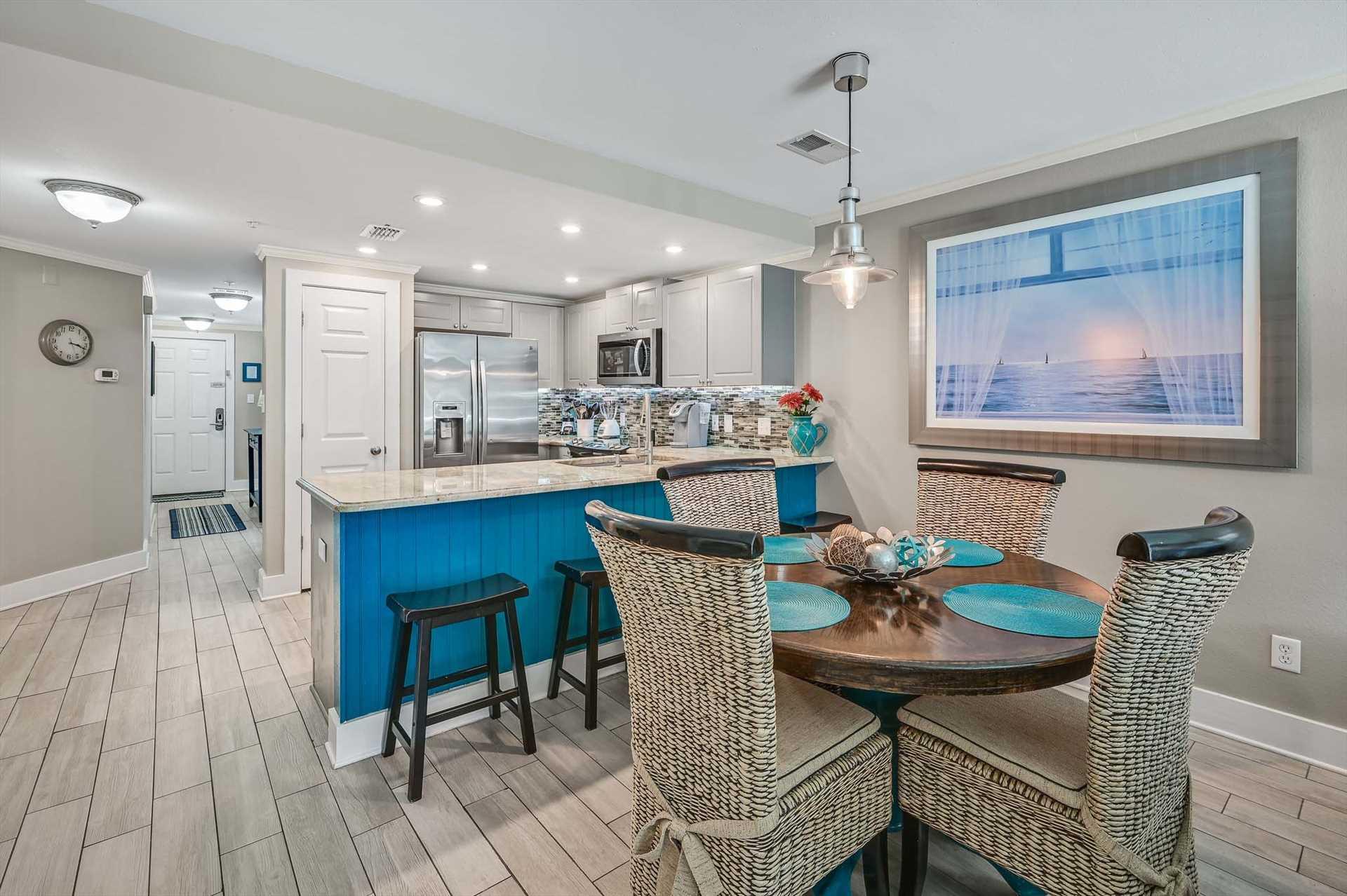 Step into this bright, open kitchen and dining space where coastal touches meet modern comfort. The vibrant island invites you to gather with loved ones, while the cozy seating sets the stage for memo