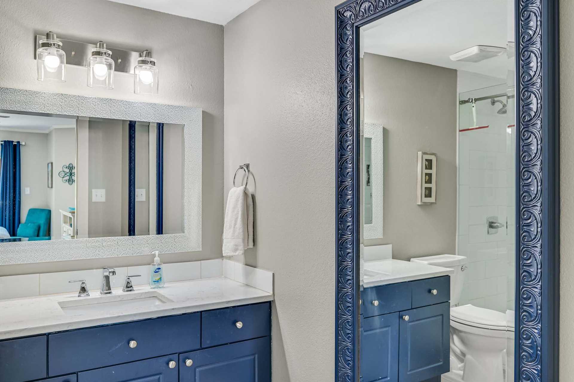 Freshen up in your stylish Primary bathroom featuring dual vanities, modern fixtures, and a spacious walkin shower with elegant frameless glass doors.