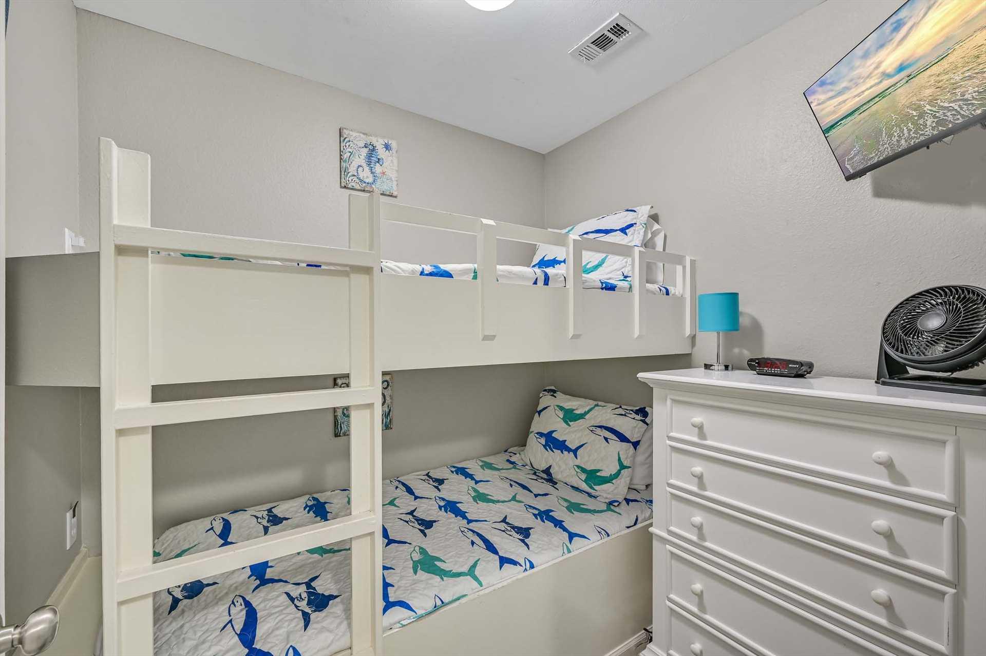 This cozy bunk room gives the kids their own cheerful space, with playful bedding and plenty of storage to keep things organized during your beach getaway.