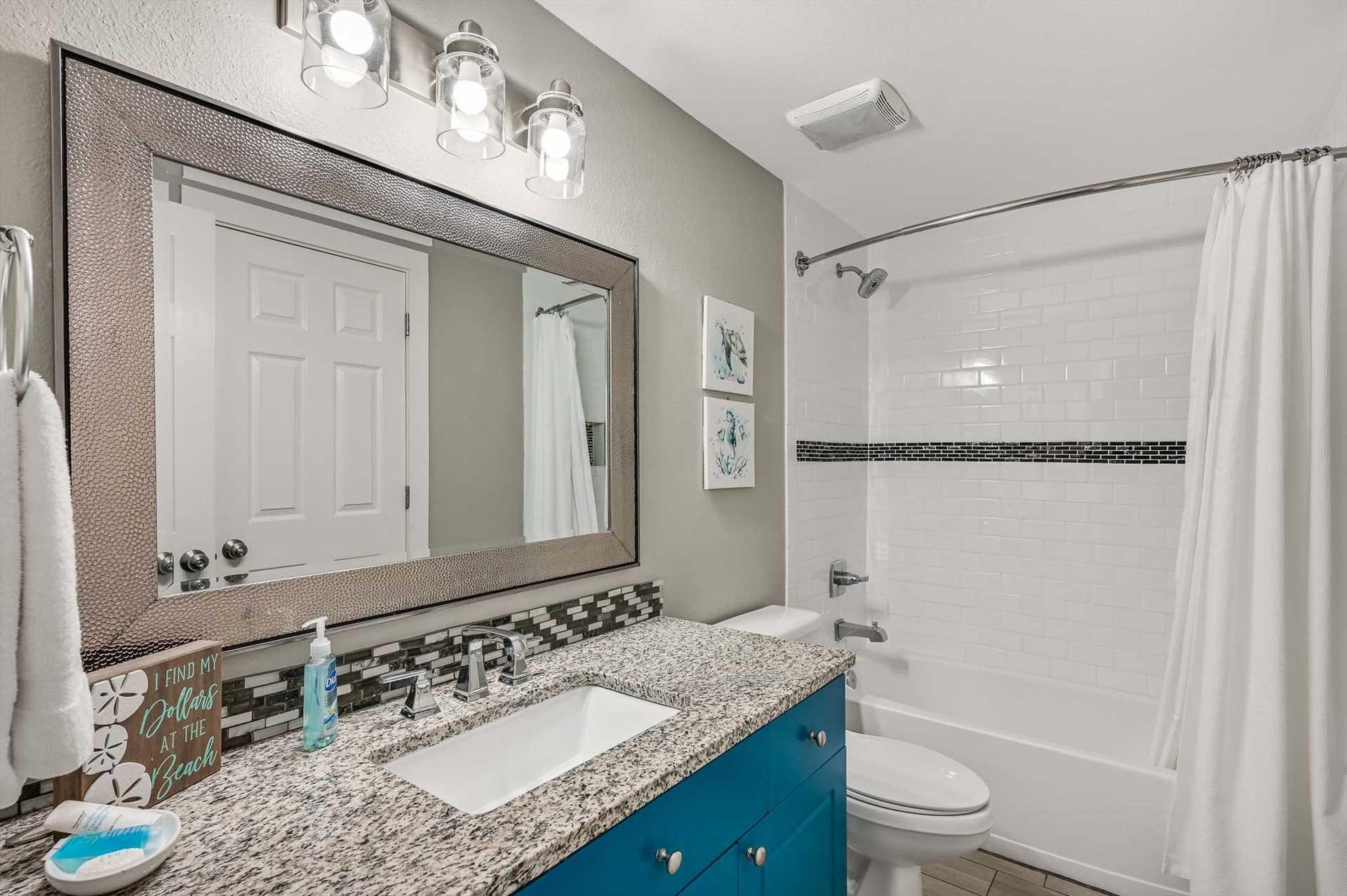Freshen up in Bathroom 2 a beautifully updated bathroom with stylish tilework, a granite vanity, and a sparkling tubshower combo—everything you need for a relaxing getaway.