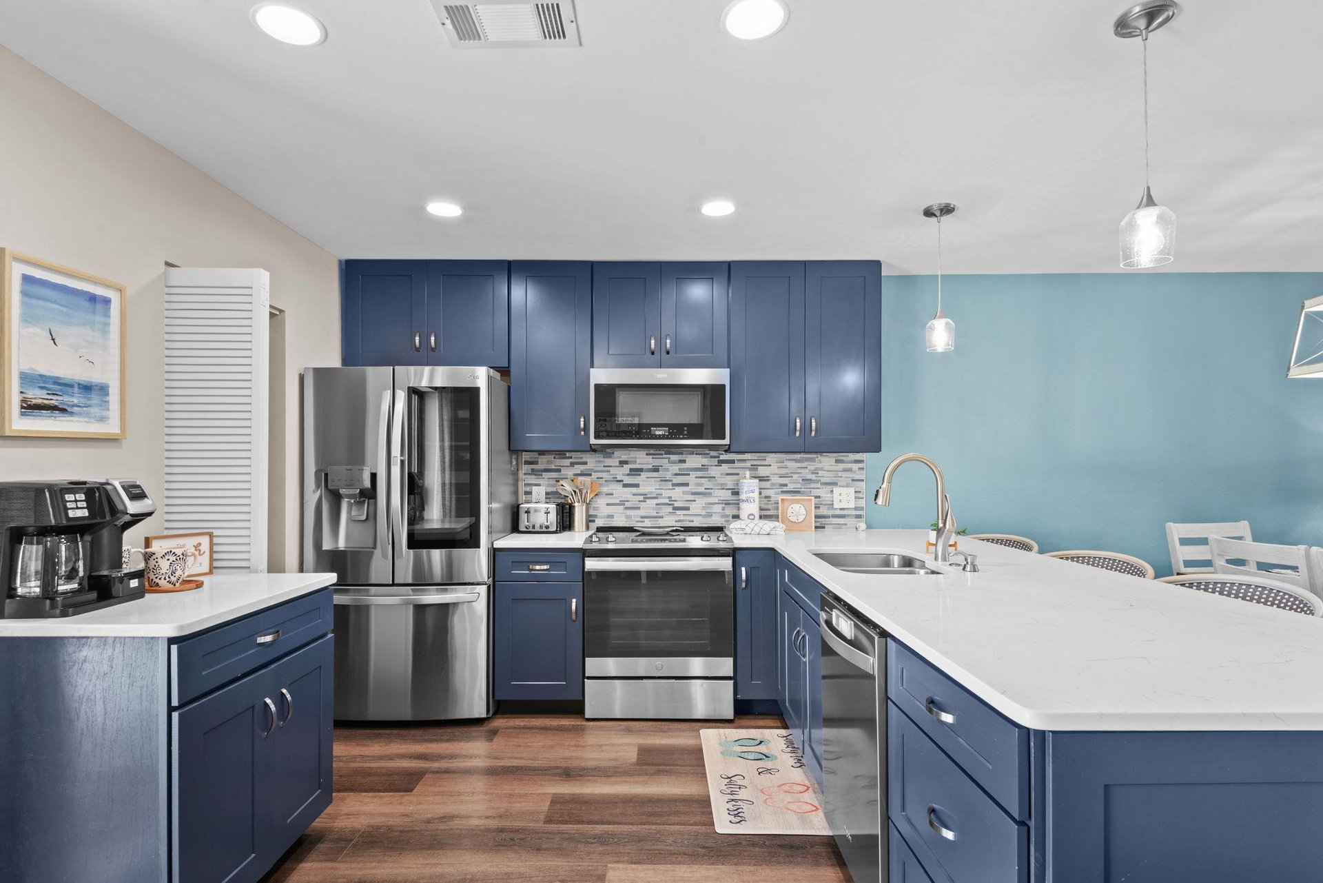 Cook your favorite meals in this spacious kitchen with modern stainless steel appliances, and a bright island perfect for gathering.