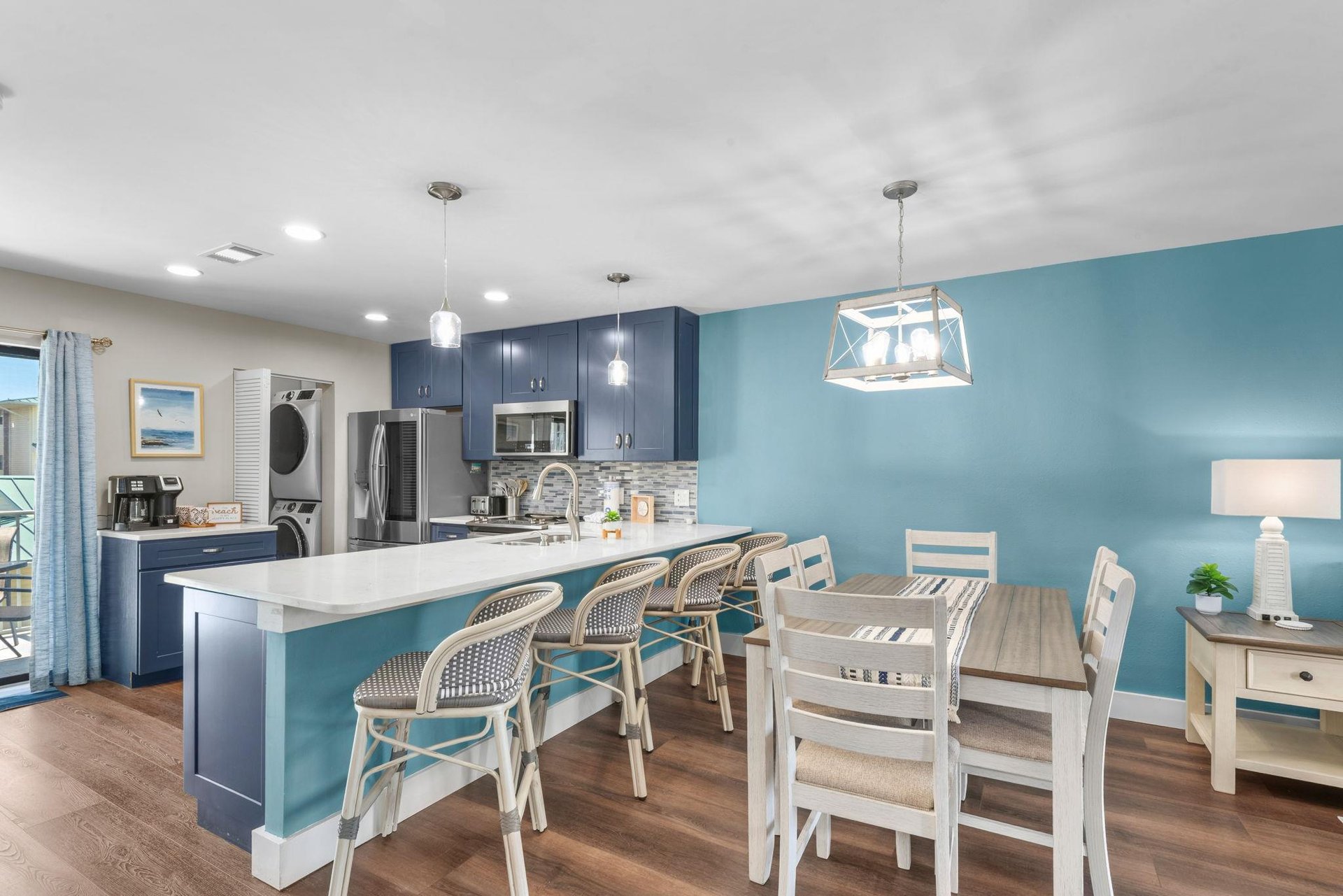 Step into your bright, open kitchen and dining space. Gather around the island, perfect spot for morning coffee or evening meals.