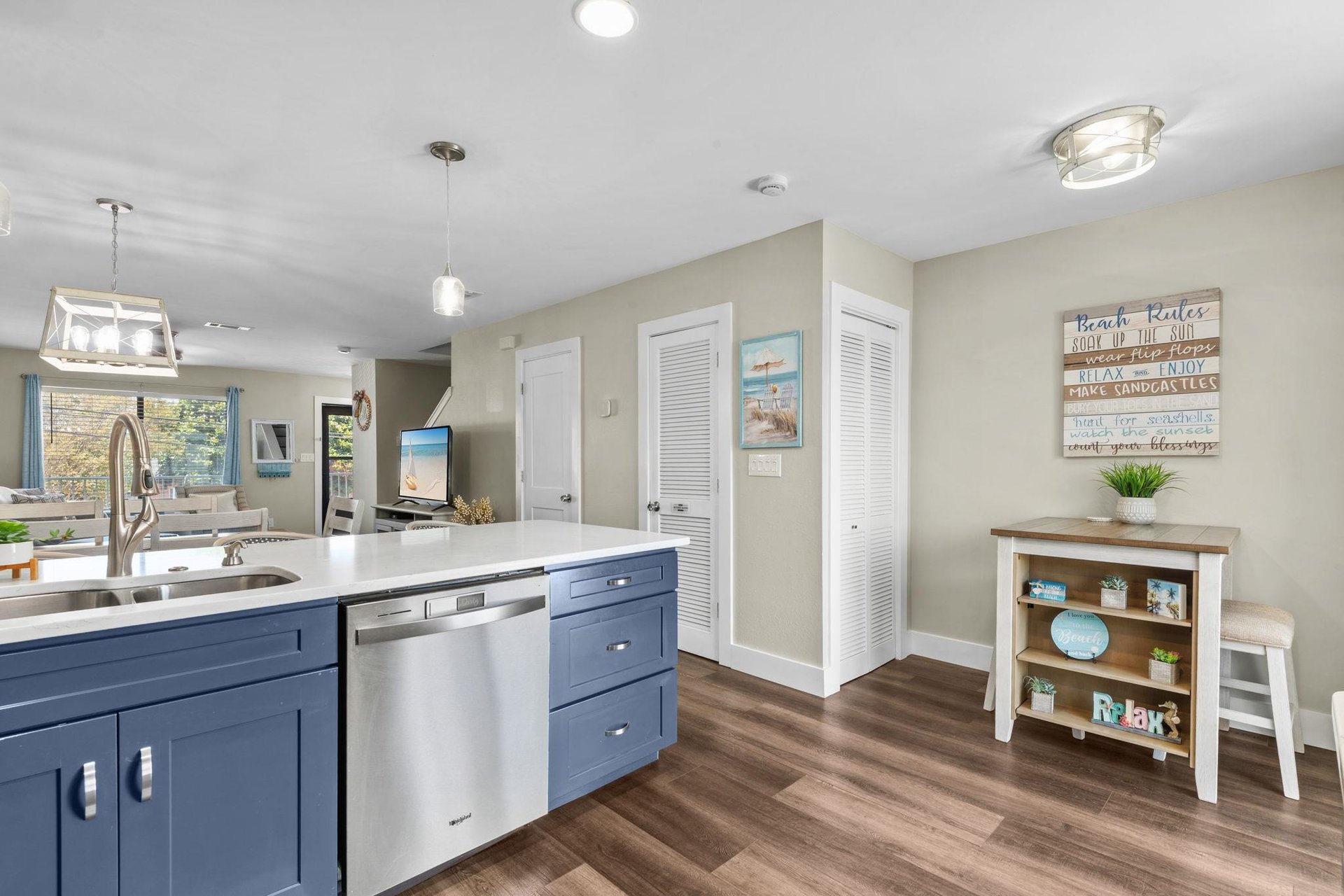 Your fully equipped kitchen invites you to whip up meals with ease, featuring stylish blue cabinetry, stainless appliances, and a spacious island perfect for gathering.
