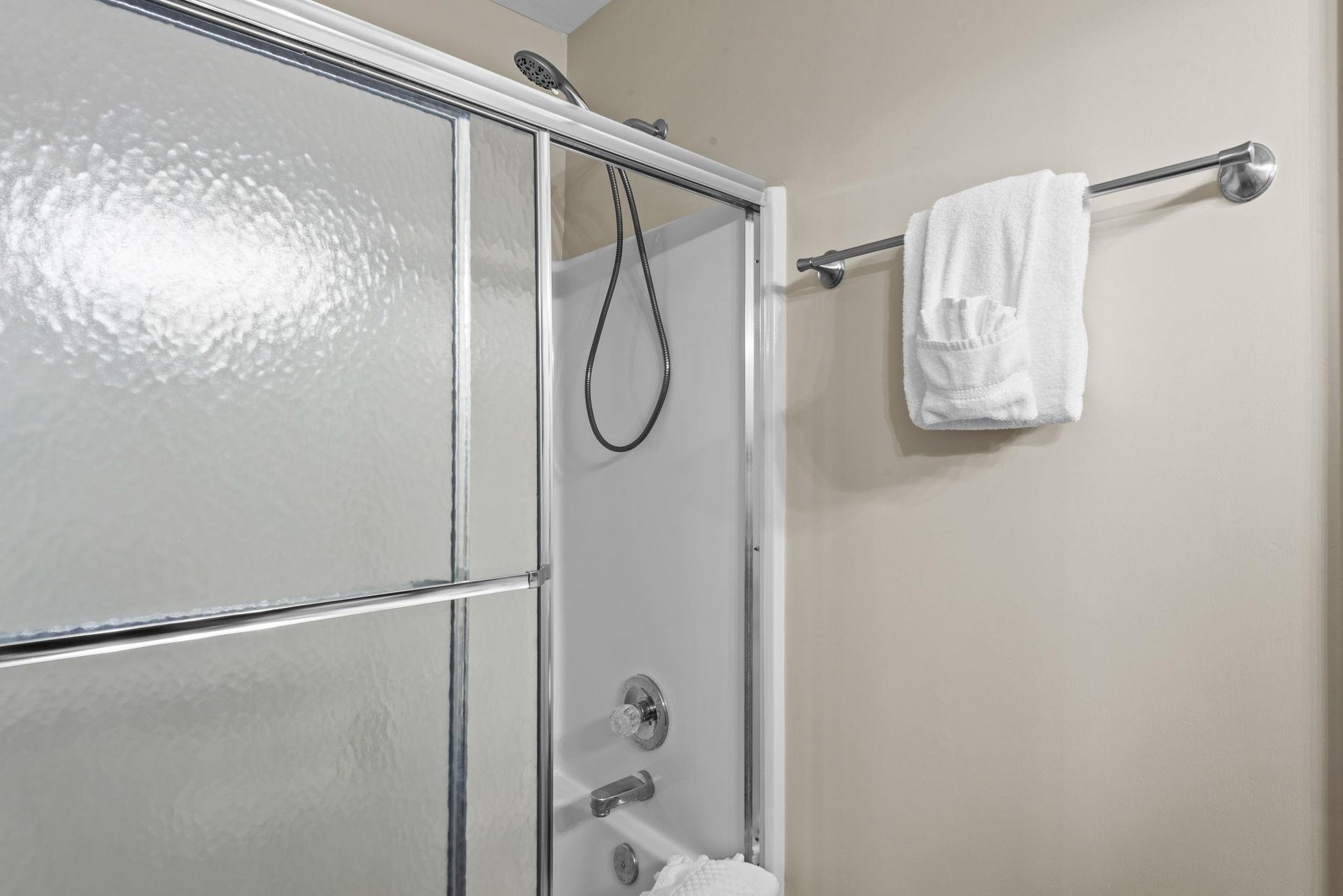 Step into your private bathroom with a glassenclosed shower, fresh towels waiting, and a tubshower combo for your relaxation.