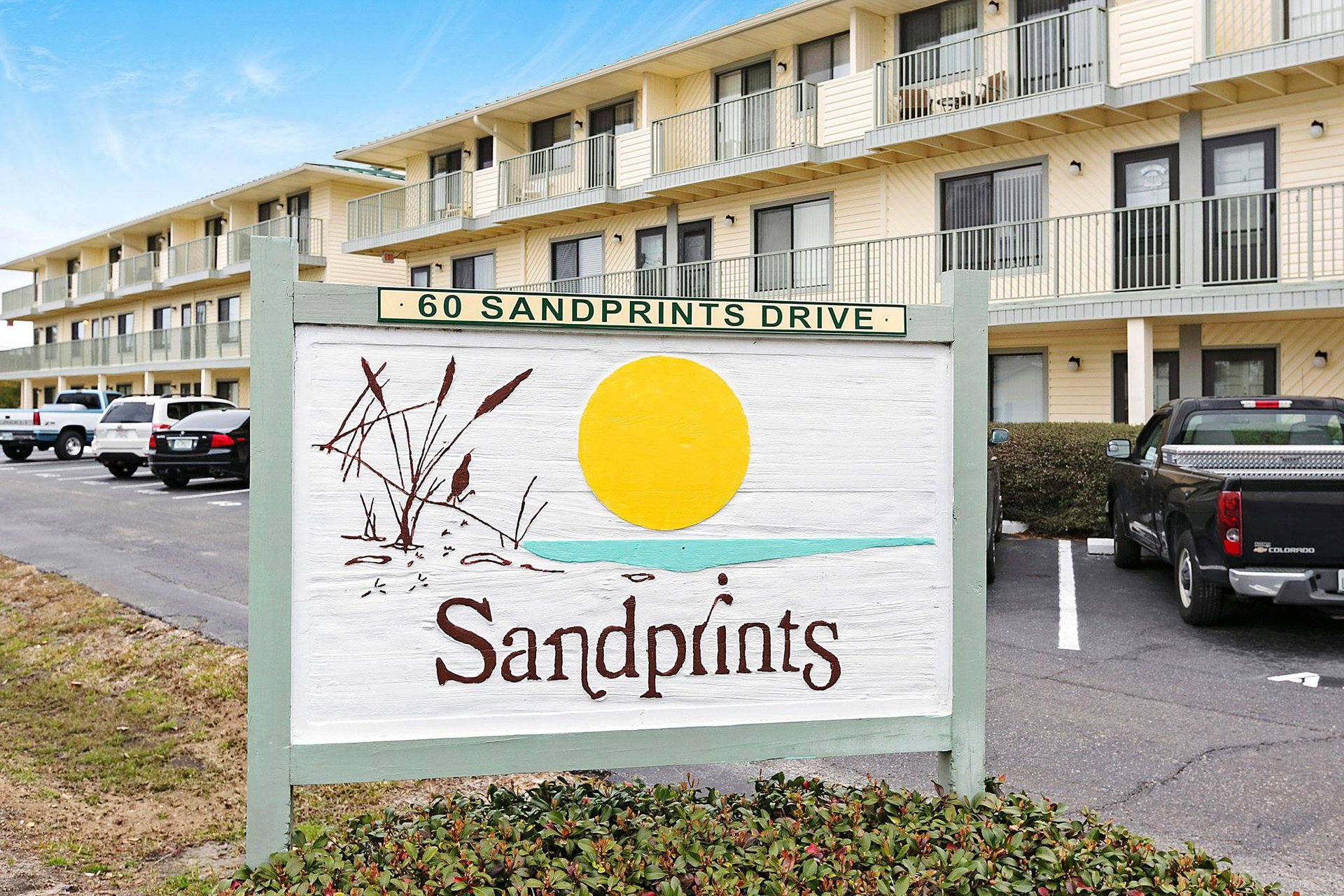 The Sandprints property welcomes guests to a coastal retreat with convenient parking and comfortable accommodations, located at 60 Sandprints Drive.