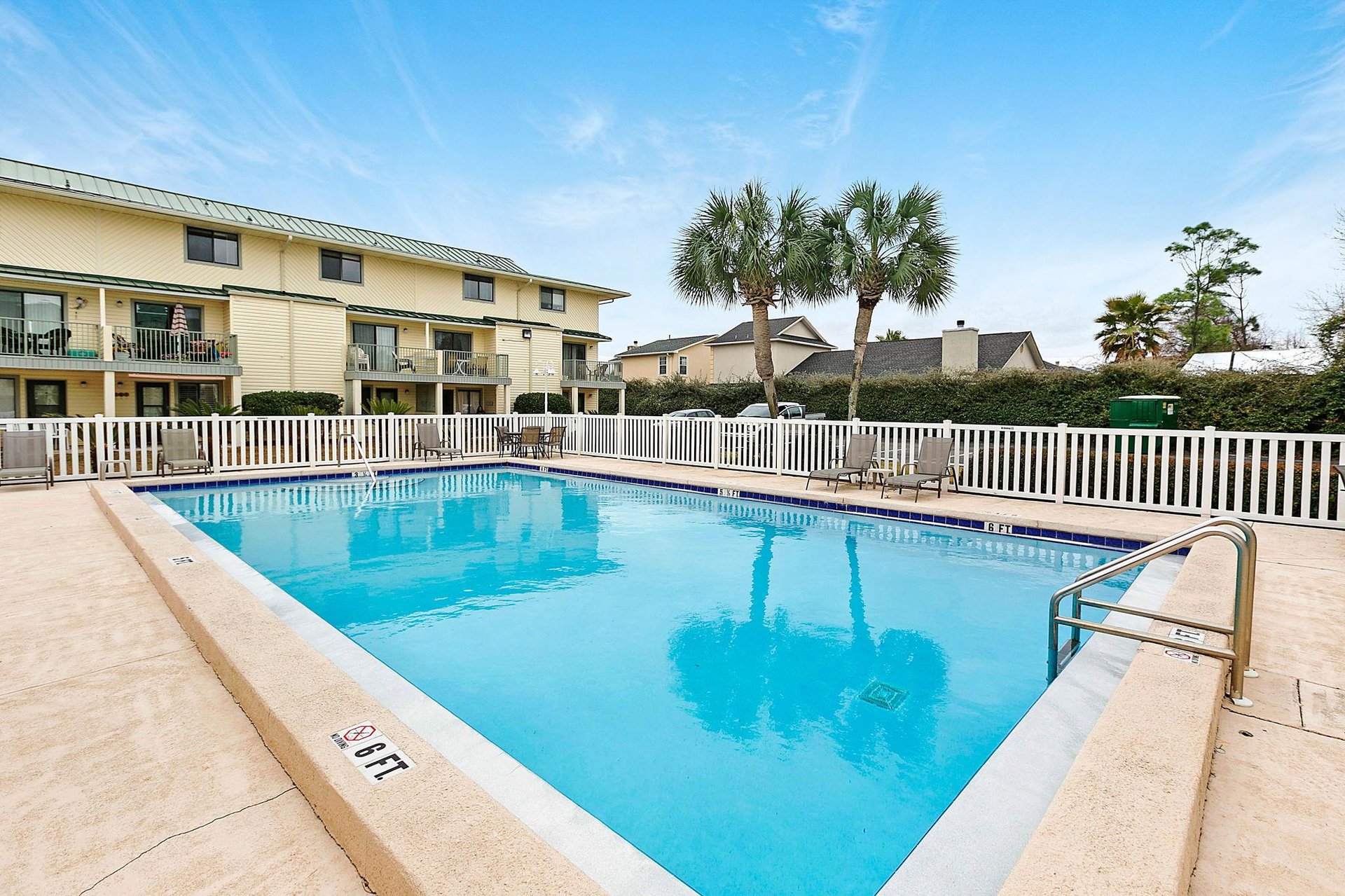 Take a refreshing dip in the sparkling outdoor pool, surrounded by palm trees and sunny skies—your perfect spot to relax and unwind.
