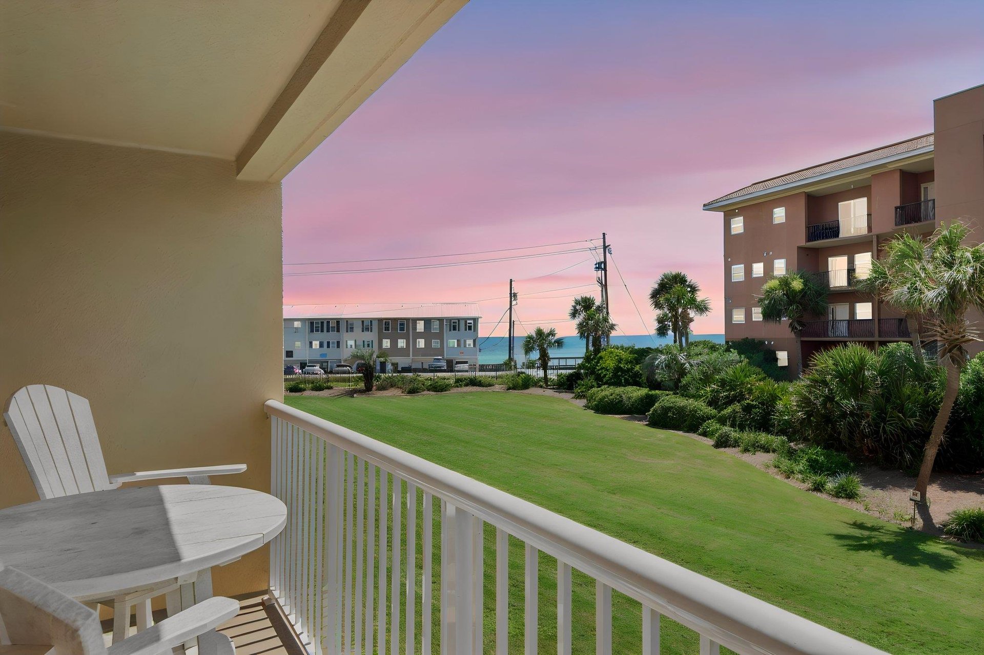 Catch stunning pastel sunsets from the balcony, where palm trees frame ocean glimpses and your coastal escape begins each evening.