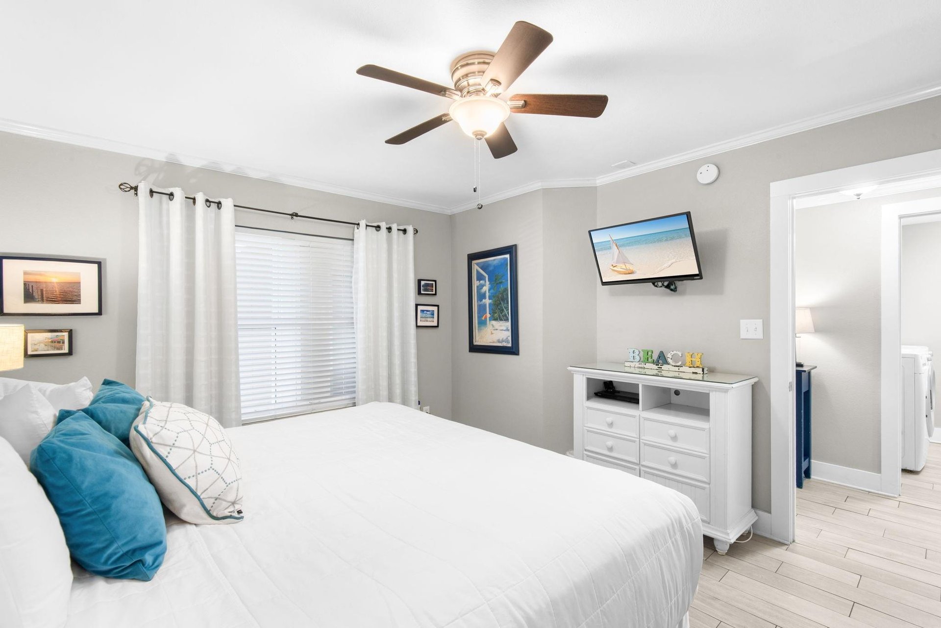 Your restful retreat features a plush bed, ceiling fan, and fresh coastal touches that invite you to unwind in comfort.