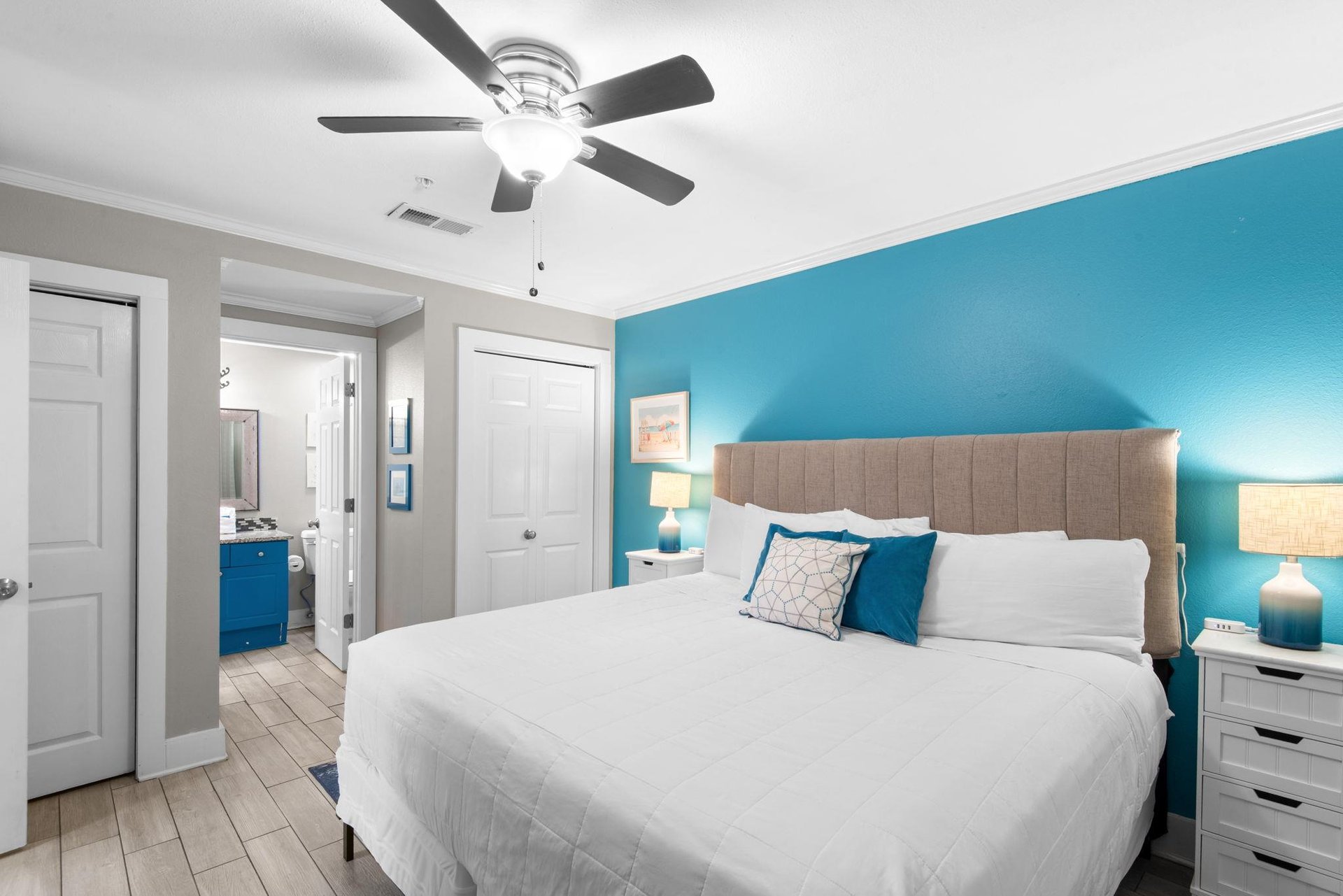 Drift off under a cooling ceiling fan, surrounded by calming oceaninspired blues that welcome you home after a day full of local activities.